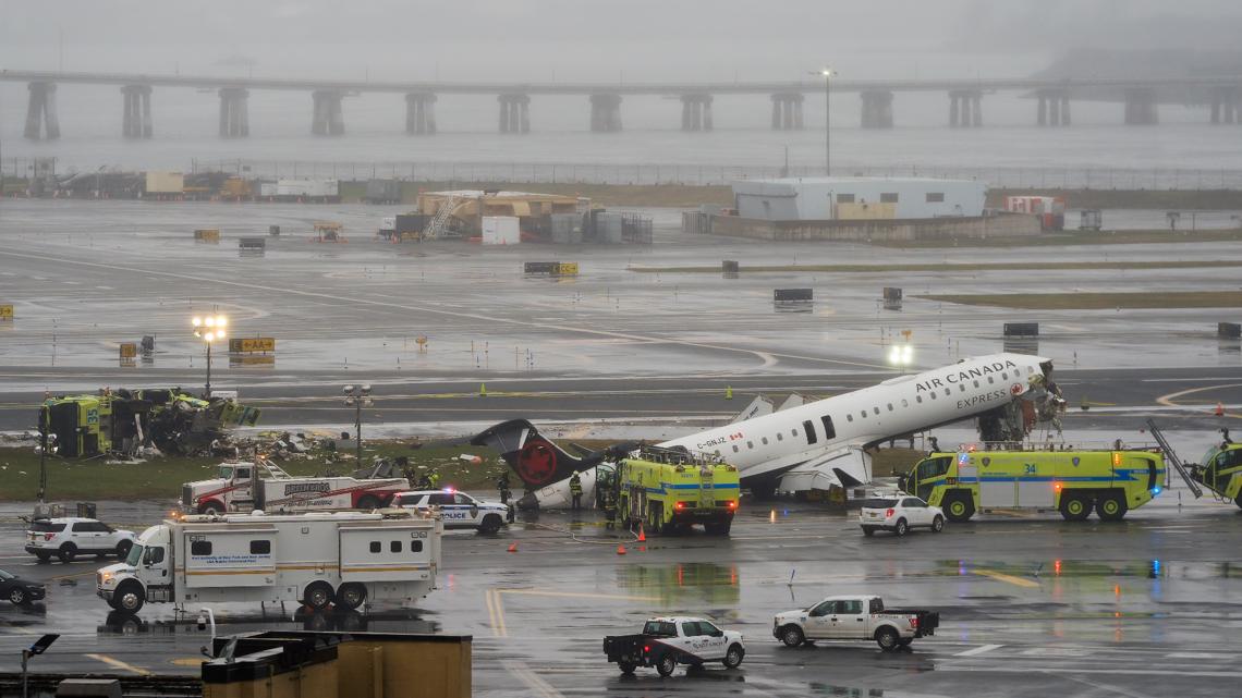 Flight attendant found buckled into seat outside plane after LaGuardia crash, reports say