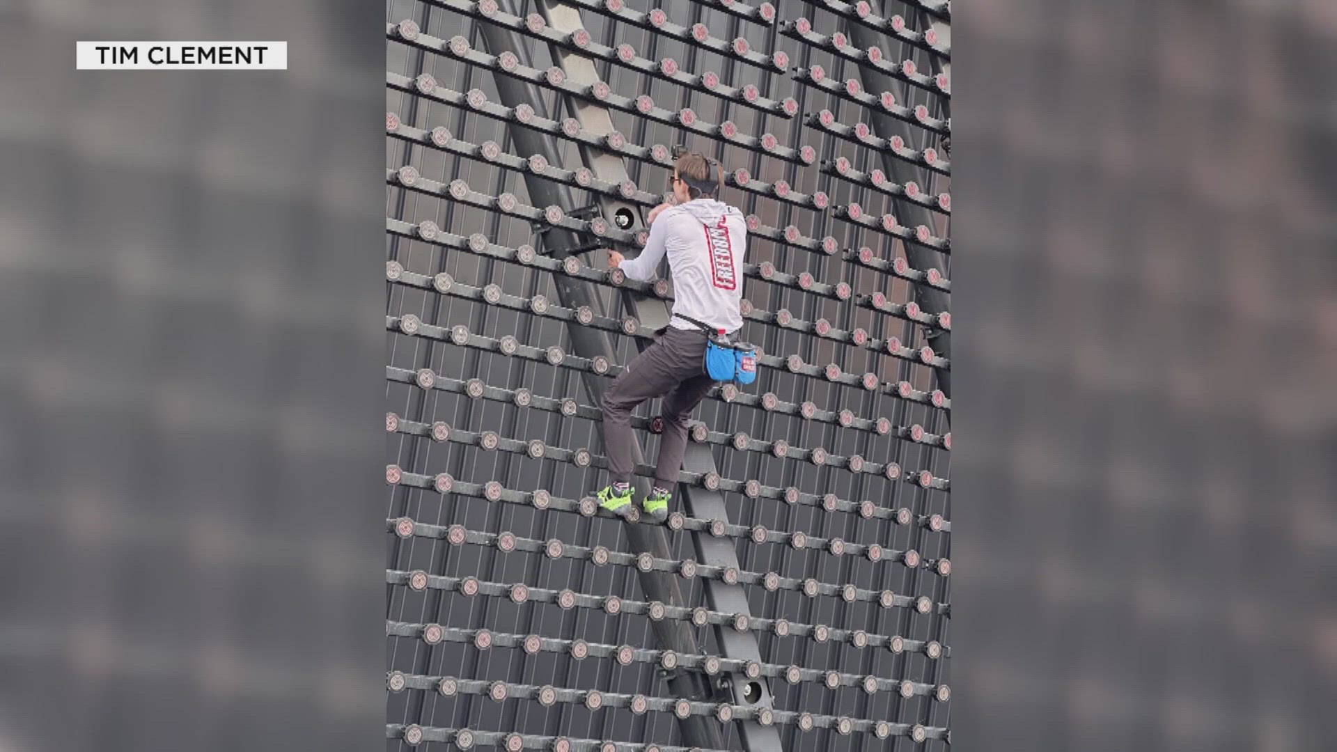 The climber was identified as Maison Deschamps, who reached the top of the 367-foot-tall venue.