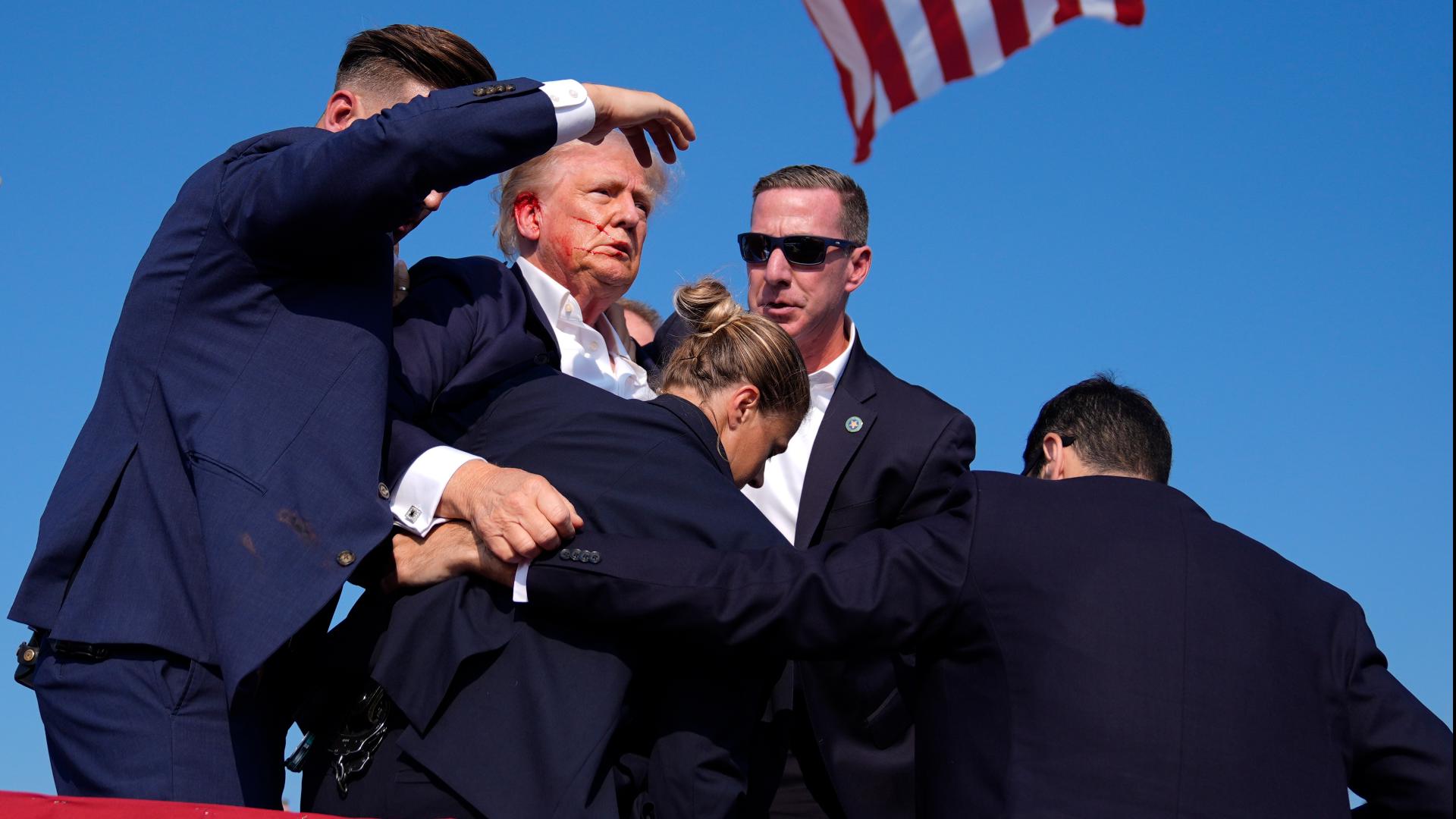 The former president appeared to have blood rushing down his face as he exited the stage.