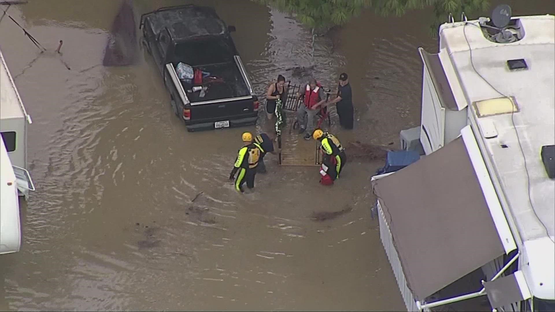 Dozens of residents rescued after record amounts of rain falls across ...