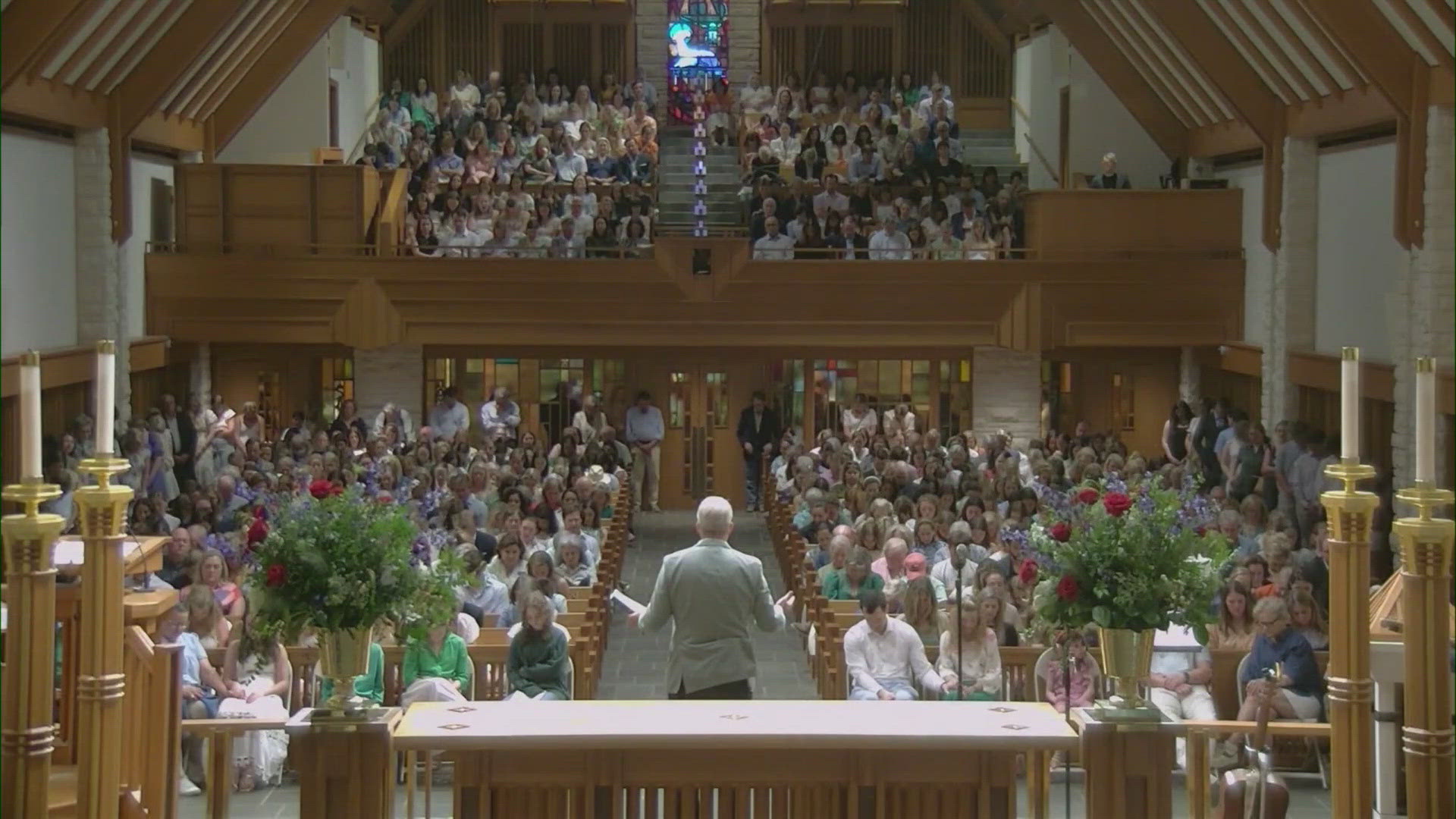 Generations of former campers with connections to Camp Mystic gathered hand and hand to sing songs and pray during a vigil.