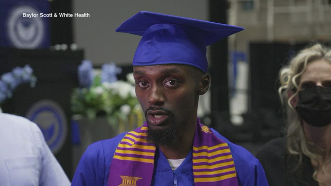 Corey Borner walks across the stage to receive UNT diploma