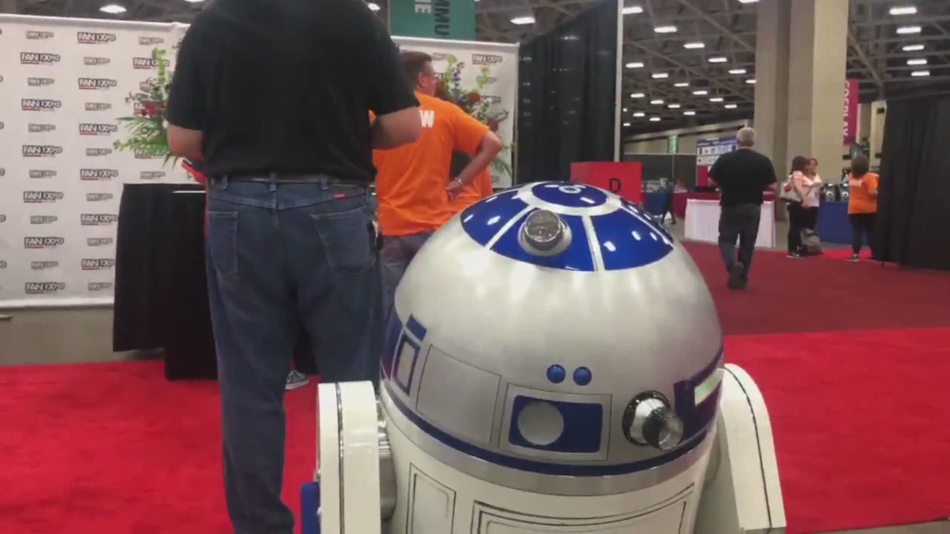 R2-D2 lined up with Star Wars fans at Fan Expo Dallas to say goodbye to a dear friend, Peter Mayhew, aka Chewbacca.