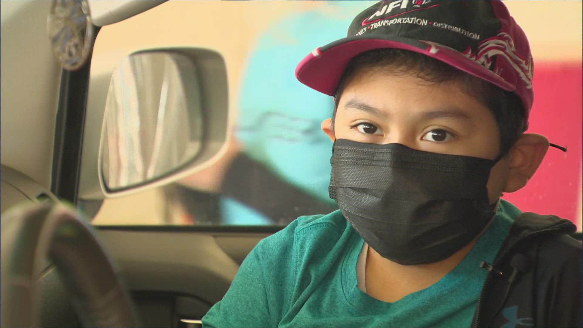 Parents took their kids for their first COVID-19 vaccine shot at the drive-thru clinic at the Dallas College Eastfield Campus in Mesquite.