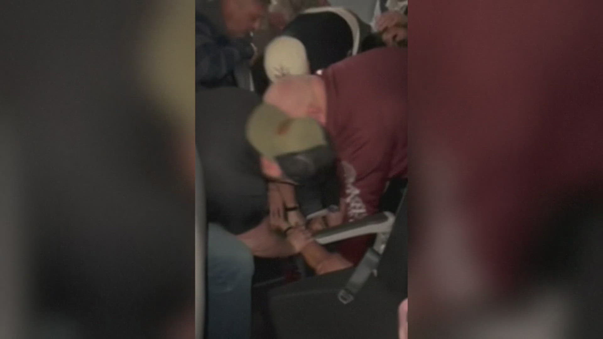 A passenger on a Frontier Airlines flight from Denver to Houston became combative and cracked a window, before others had to restrain him, authorities said.