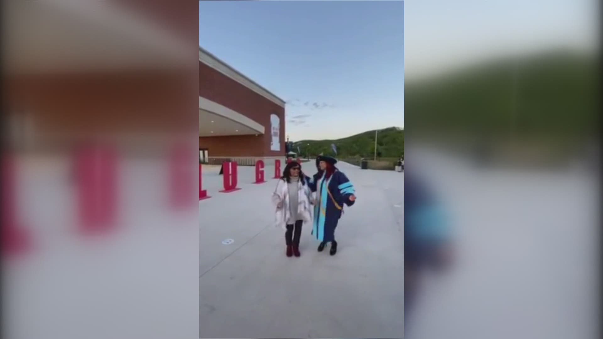 This woman just earned her doctorate, and she's dancing with Mom to celebrate.