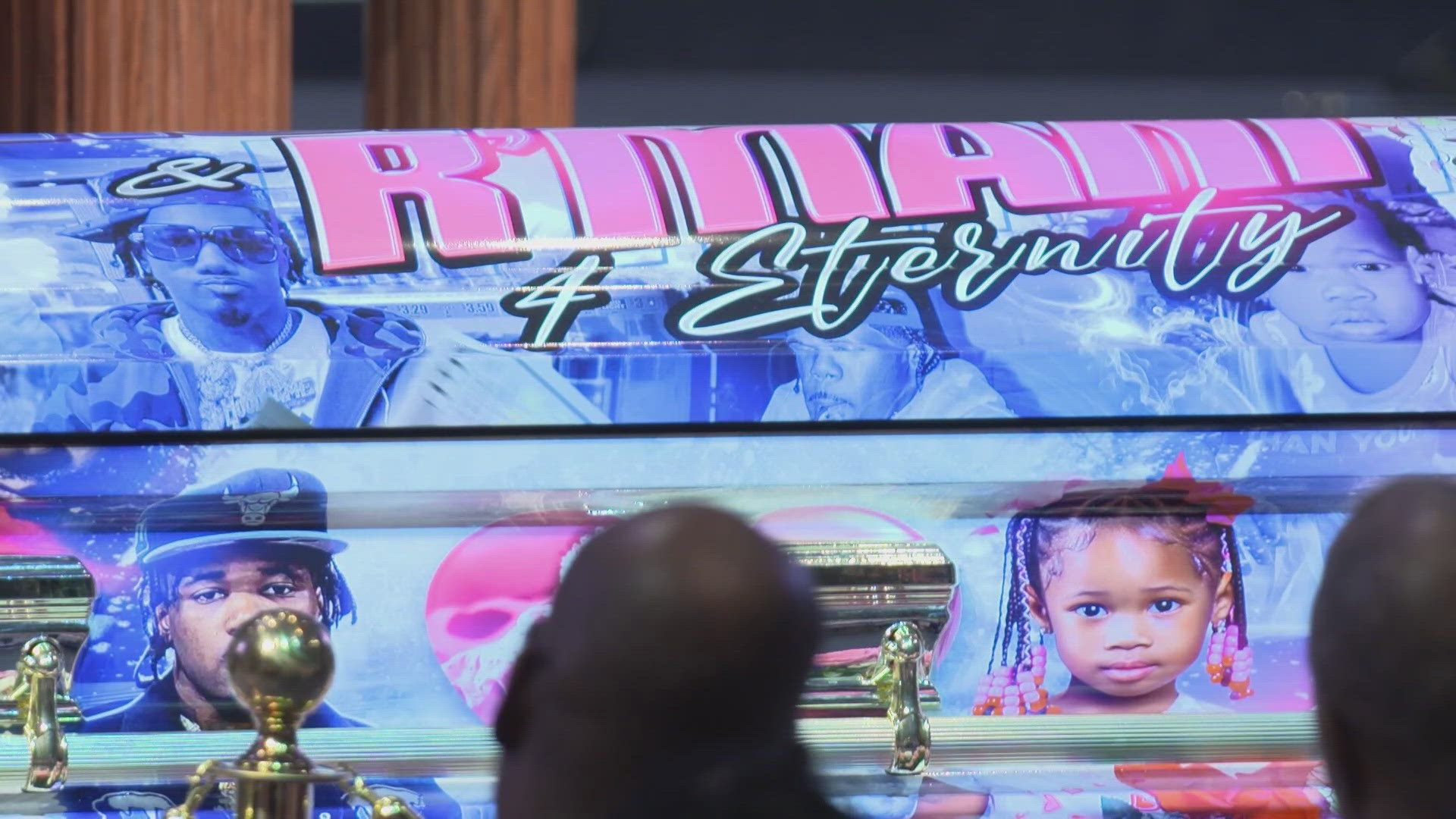 The celebration of life included caskets wrapped with images of Ronnie also known as "Chuckie" and R'Mani. The father and daughter will be buried together.