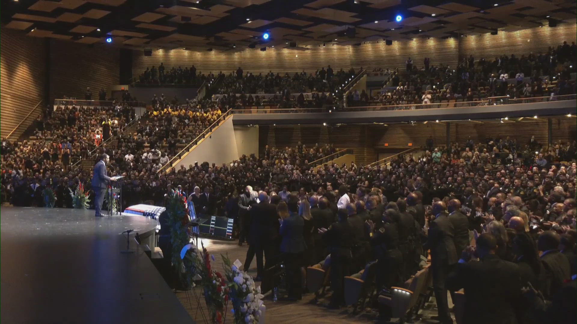 Those attending officer Burks' celebration of life gave a standing ovation and applause for his mother after Dallas Mayor Eric Johnson thanked her.