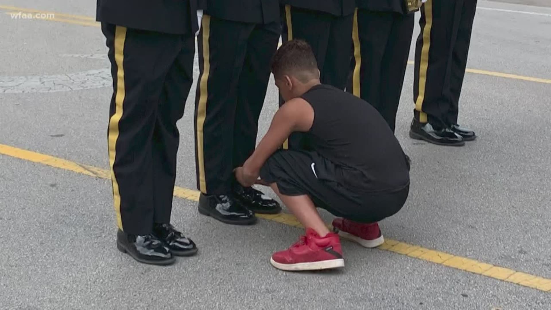 11-year-old Josh Brown meets Officer Jerrick Wilson after helping him at the Fourth of July parade in Arlington.