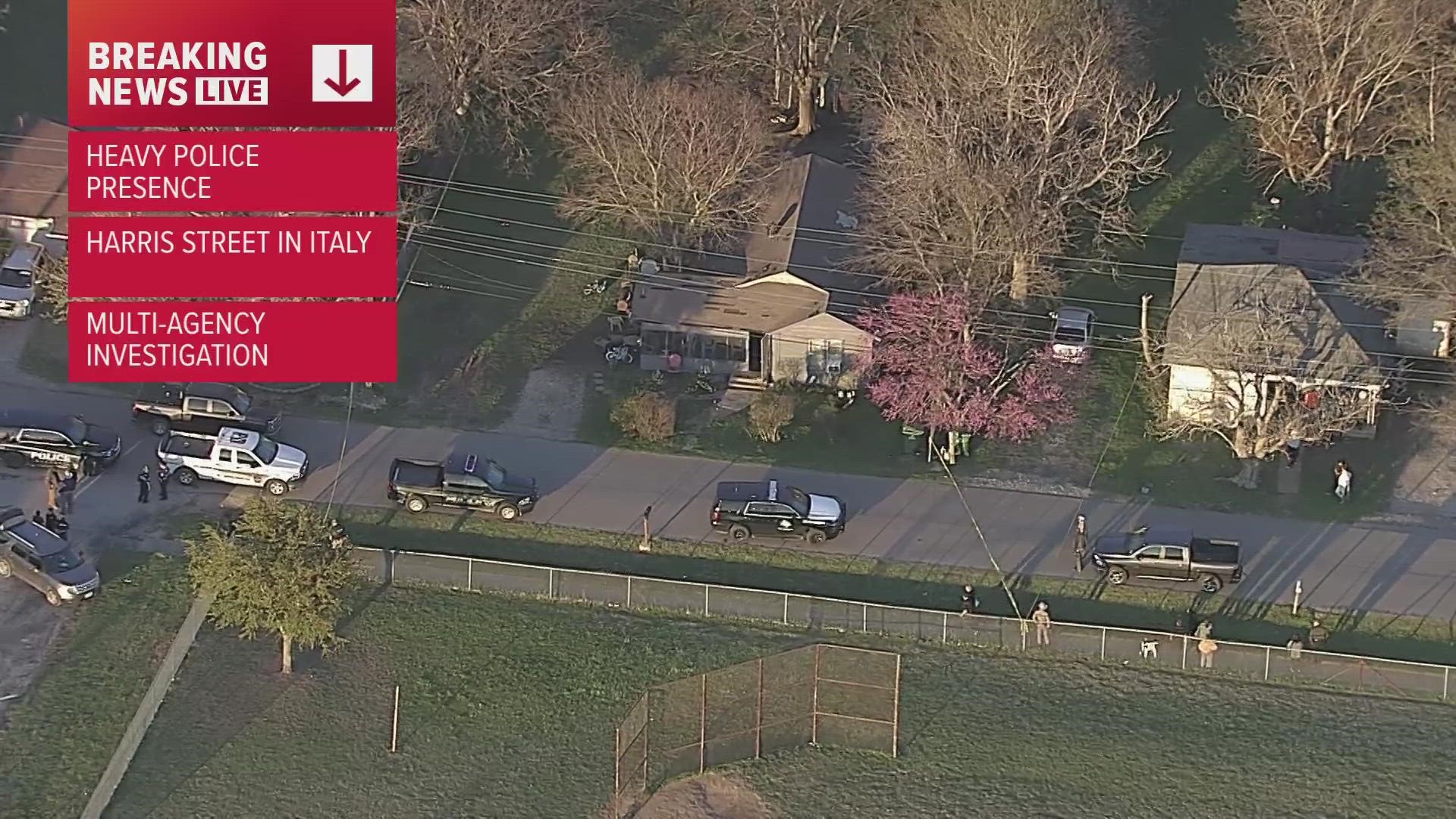 A large police presence is seen outside a home in Italy, Texas in Ellis County.