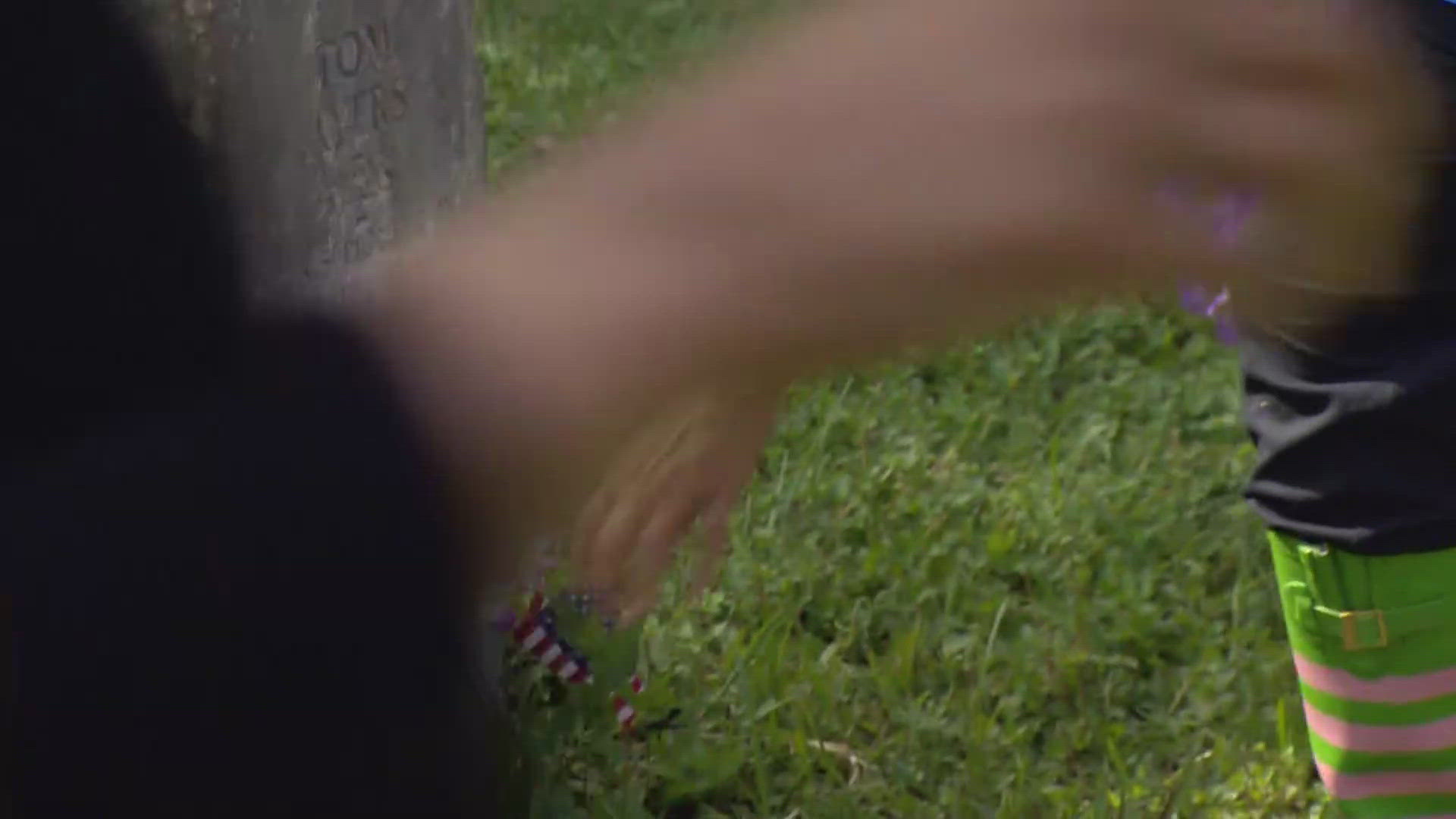 Alpha Kappa Alpha and Alpha Psi Omega members placed flowers and American flags on the graves. Work began in May.