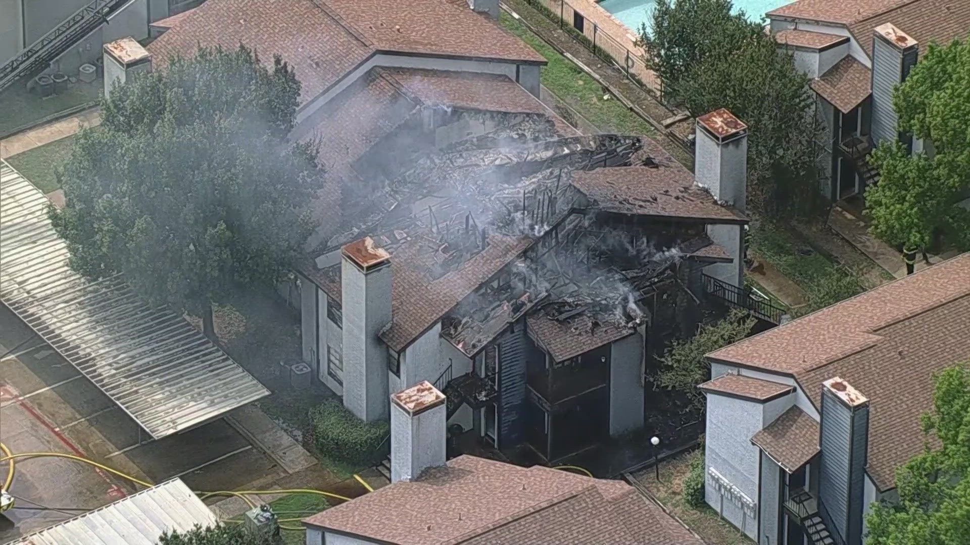 A fire broke out at the Morgan Apartments in Bedford, Texas, leaving a massive hole in the roof.