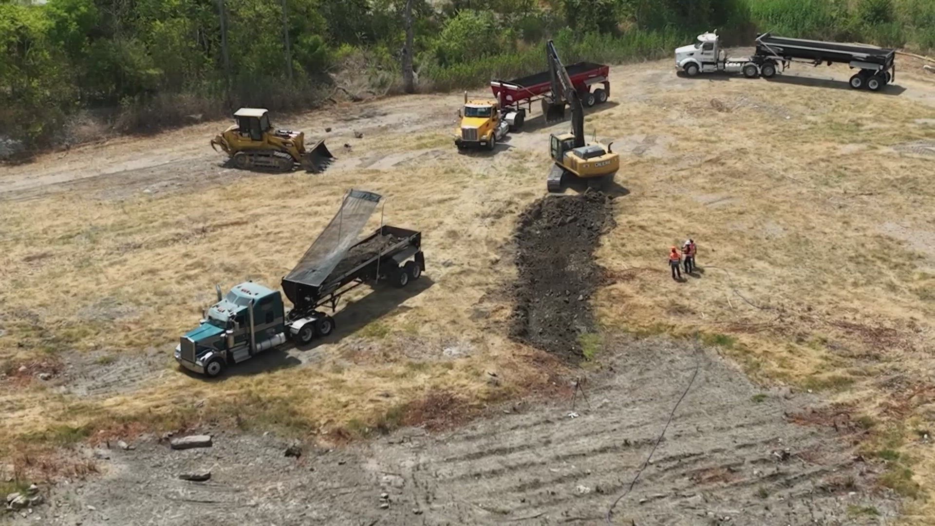 Dallas crews began removing lead-contaminated dirt from the 'Shingle Mountain' recycling site to a landfill in the latest clean-up efforts.