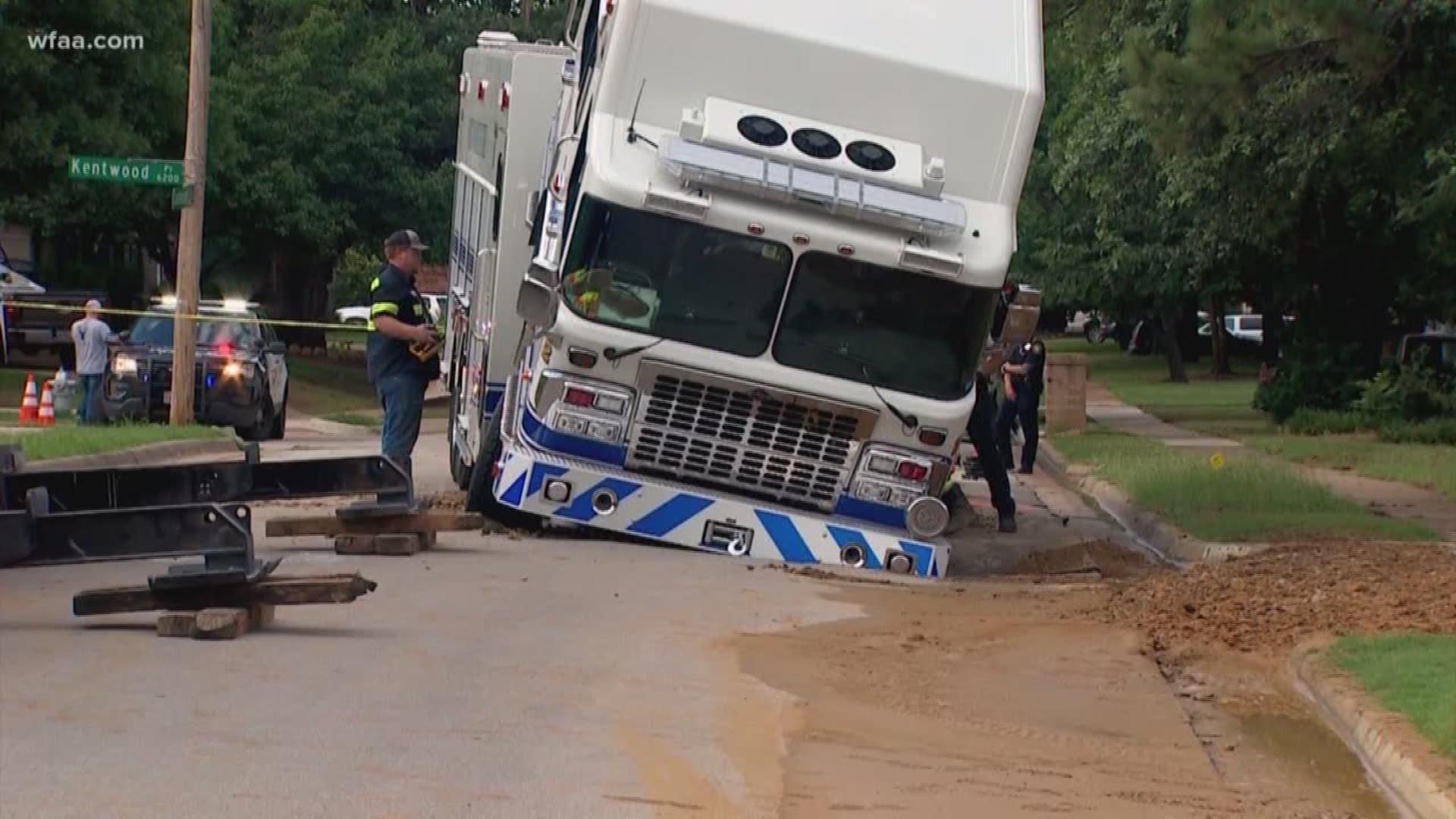 The front of a fire truck sank into the road where a water main broke on June 12, 2019 in Fort Worth.