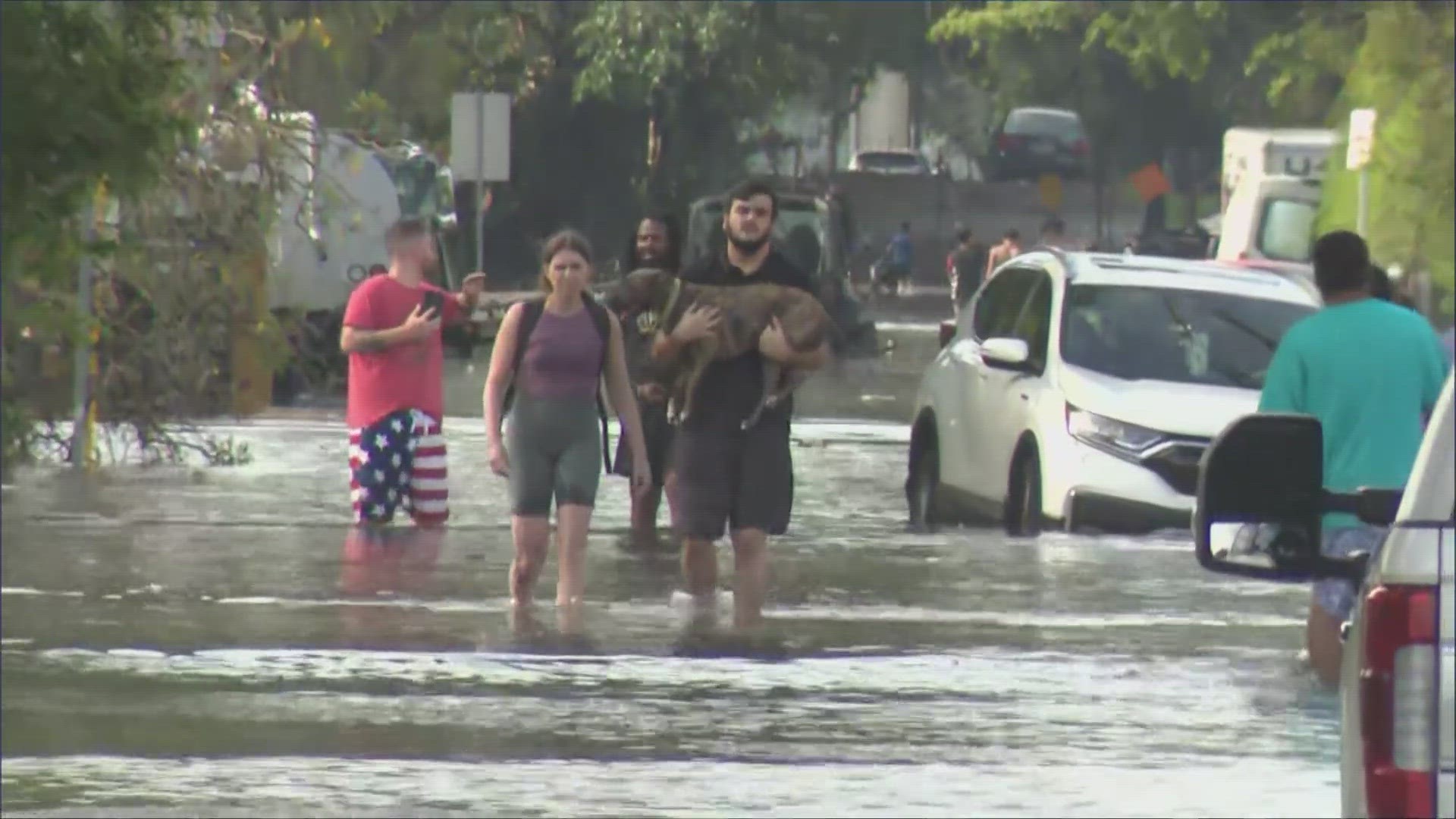 Flash flooding prompted dozens of emergency rescues and forced drivers to abandon their cars, officials said.