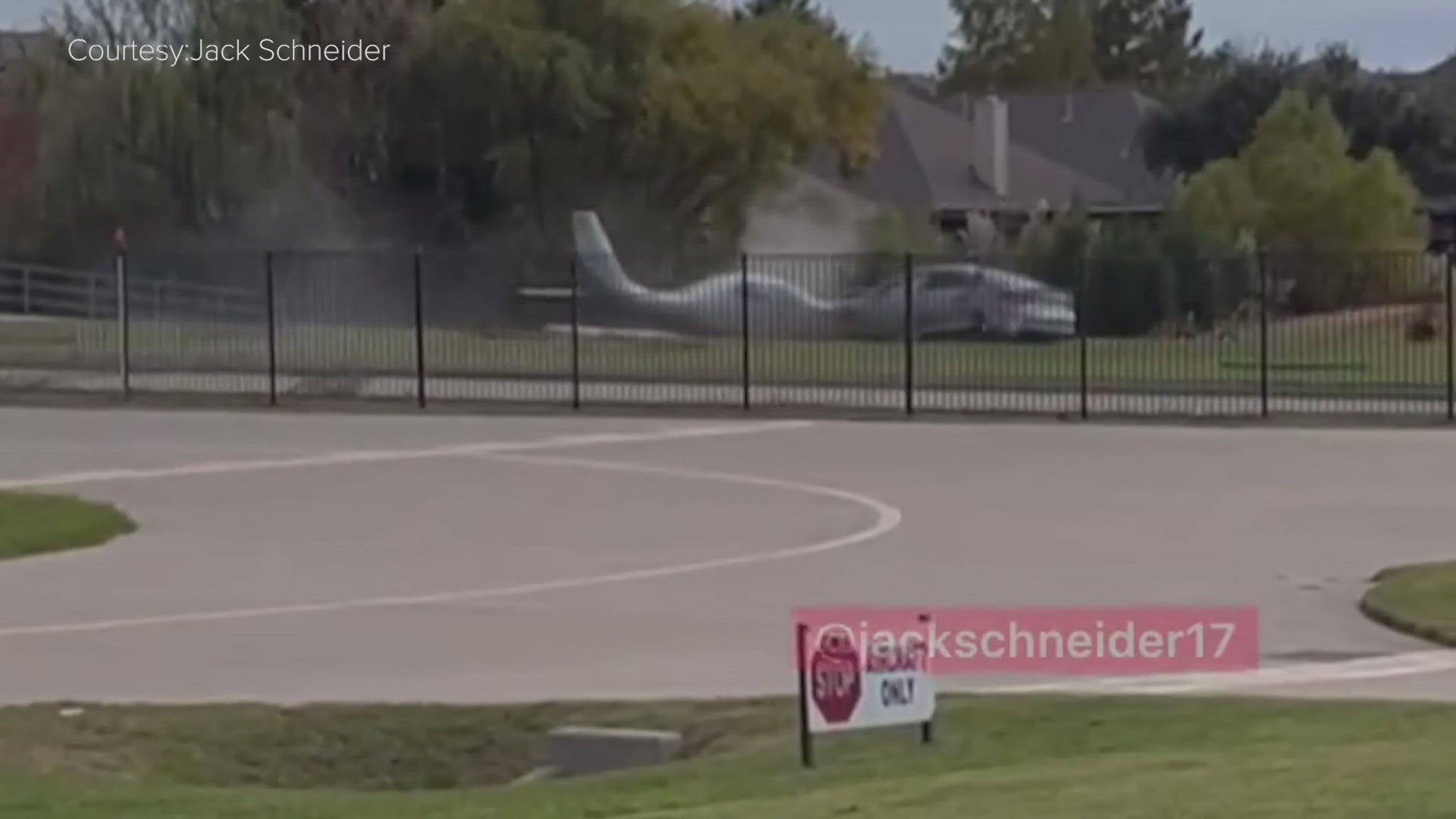 Video from a witness showed the Lancair LX7 plane crashing through a fence at the end of the runway and colliding with a car that was traveling on a road.