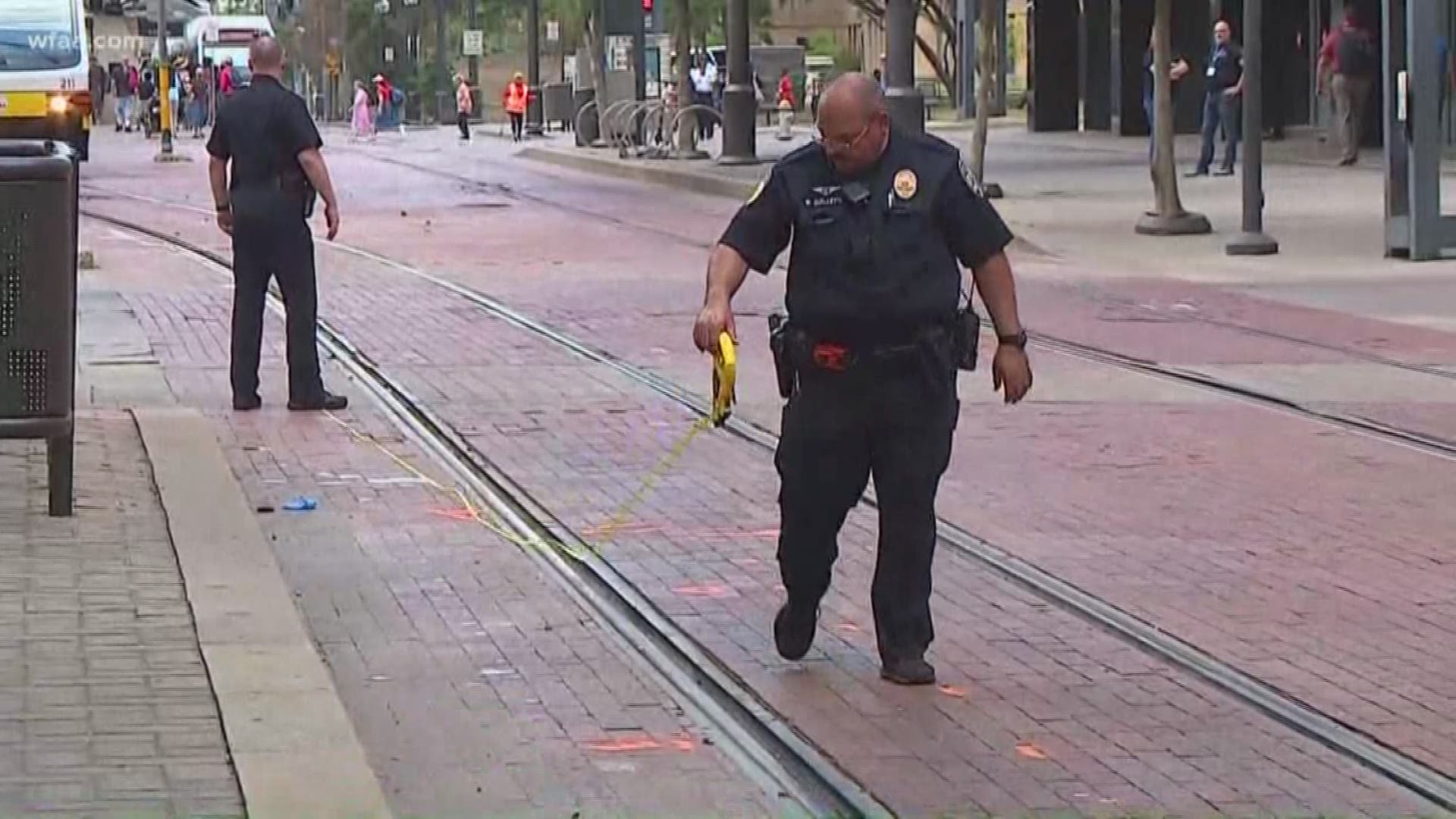 The officer was wearing headphones when he was hit by the train while walking along Olive Street at Bryan Street, Dallas police sources say.