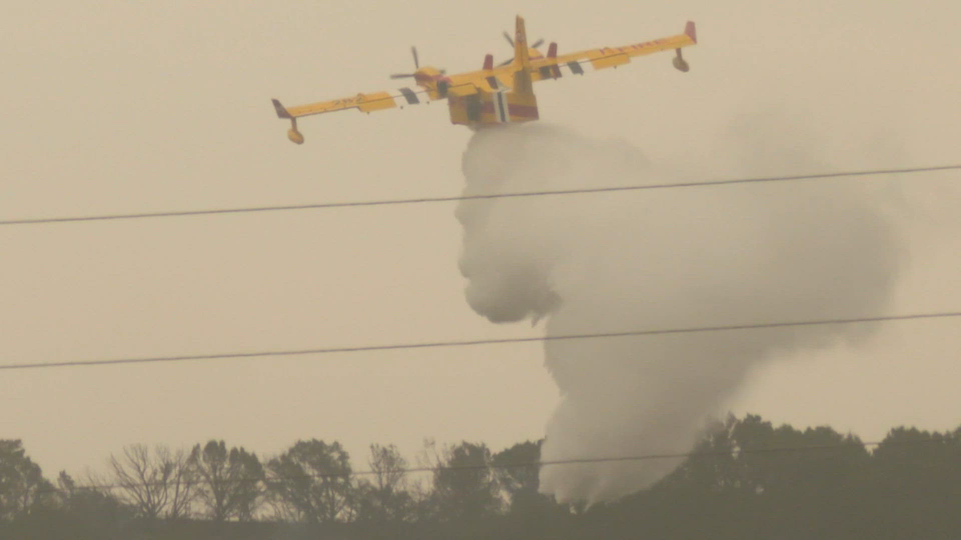 Neighbors load up truck with hay to feed livestock as wildfire burns ...