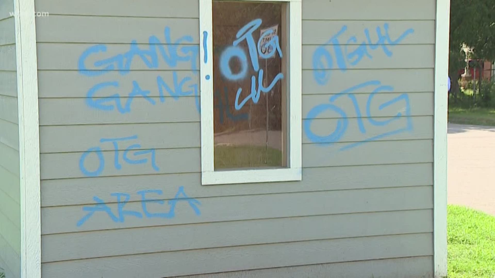 Gang tags painted on school bus shelter
