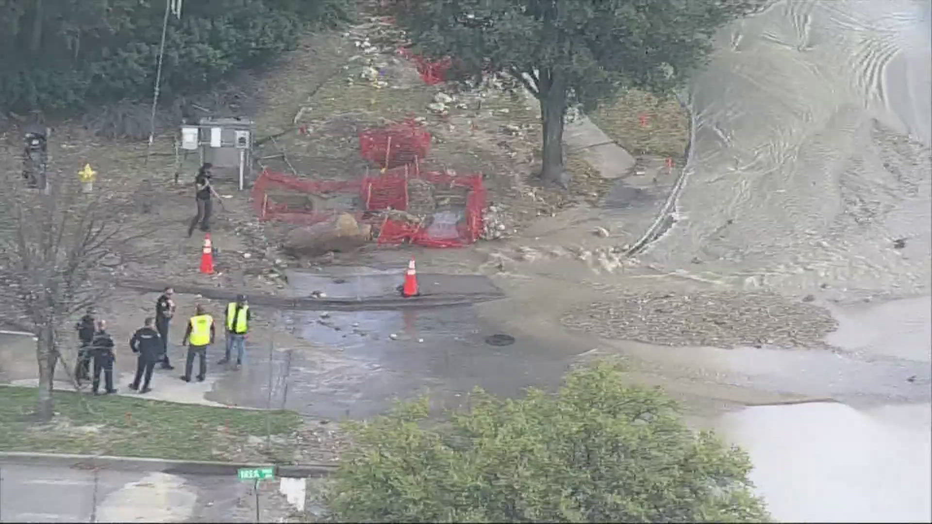 Crews work to repair a water main break that shut down a road in Frisco ...