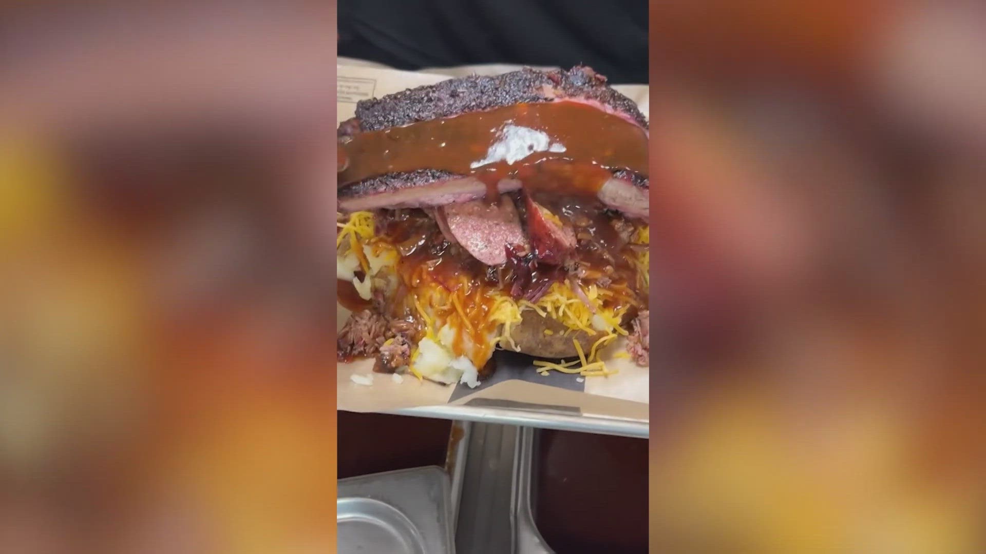 MJ's House of Smoke in Arlington serves up a baked potato piled with cheese, butter, and three kinds of meat soaked in barbecue sauce.