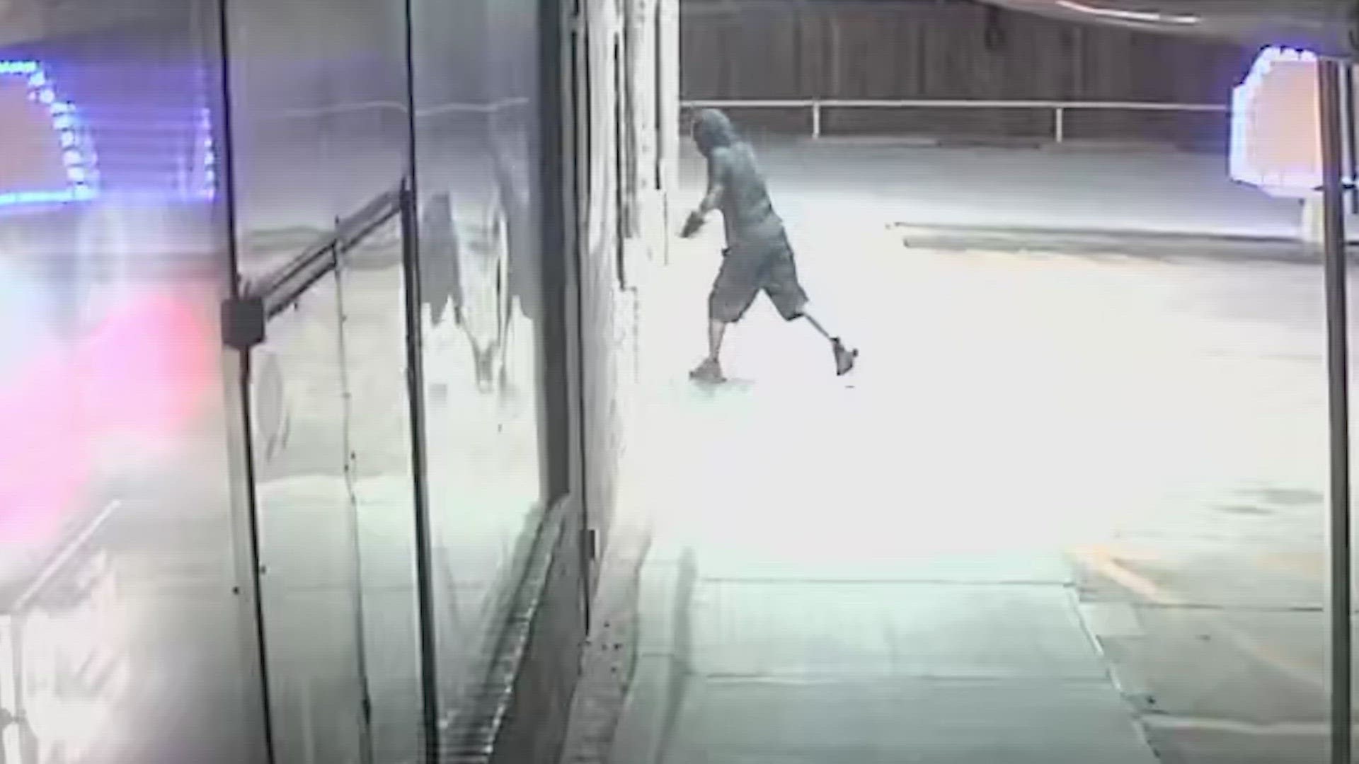 Surveillance footage shows a masked person walk to the restaurant and shatter several glass windows.