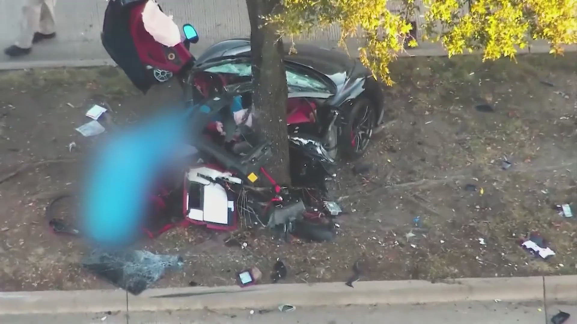 A McLaren sports car split in two after hitting a median tree on Abrams Road in Dallas.