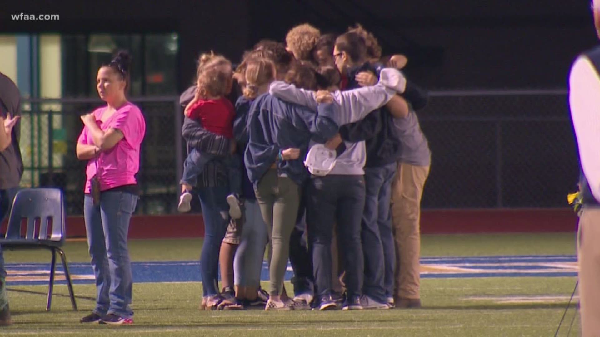 Hundreds gathered Wednesday night at Community High’s football field for a vigil.