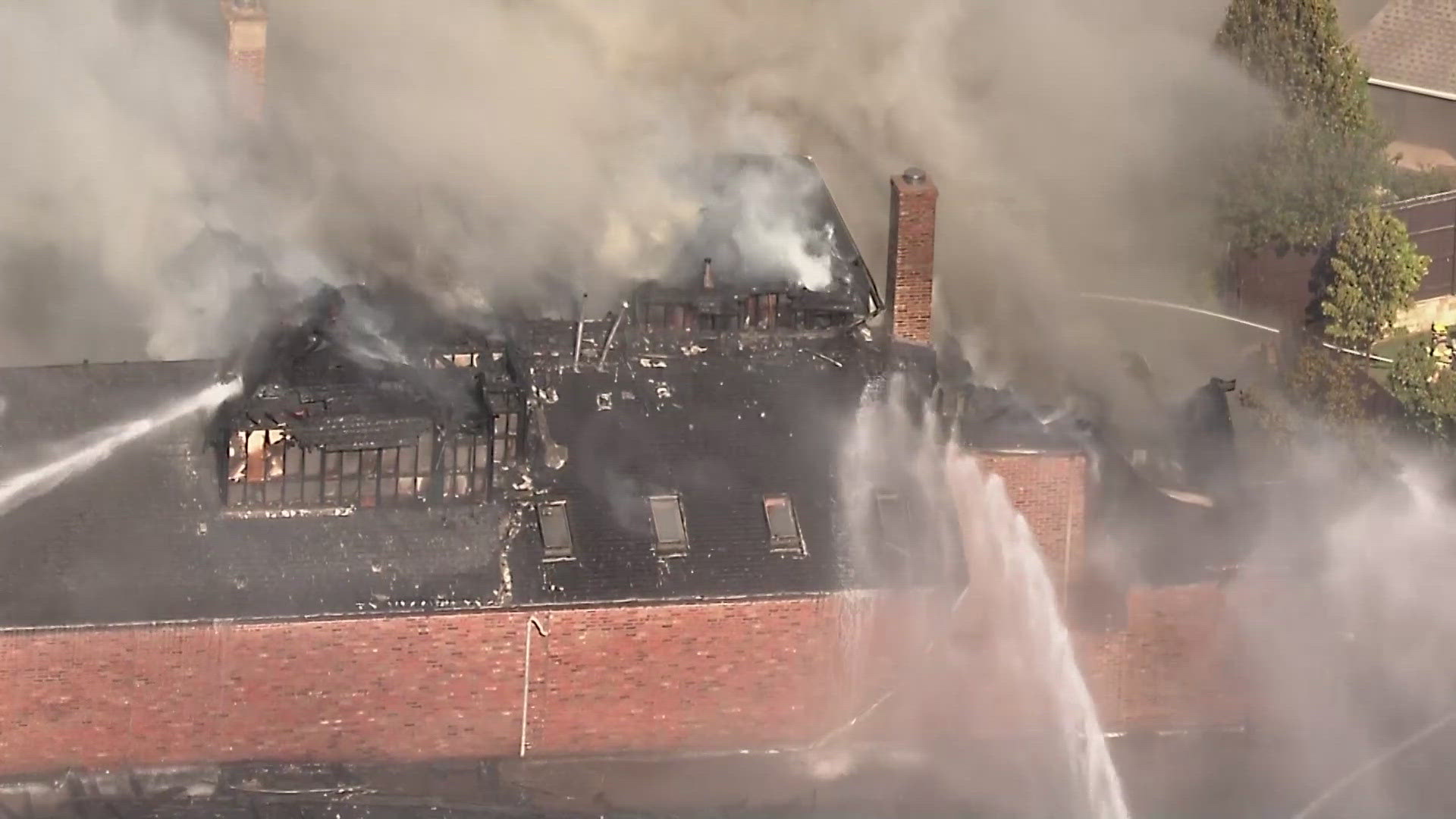 Firefighters are working to put out a fire at a house in a neighborhood just east of the DNT in Frisco on April 22, 2024.