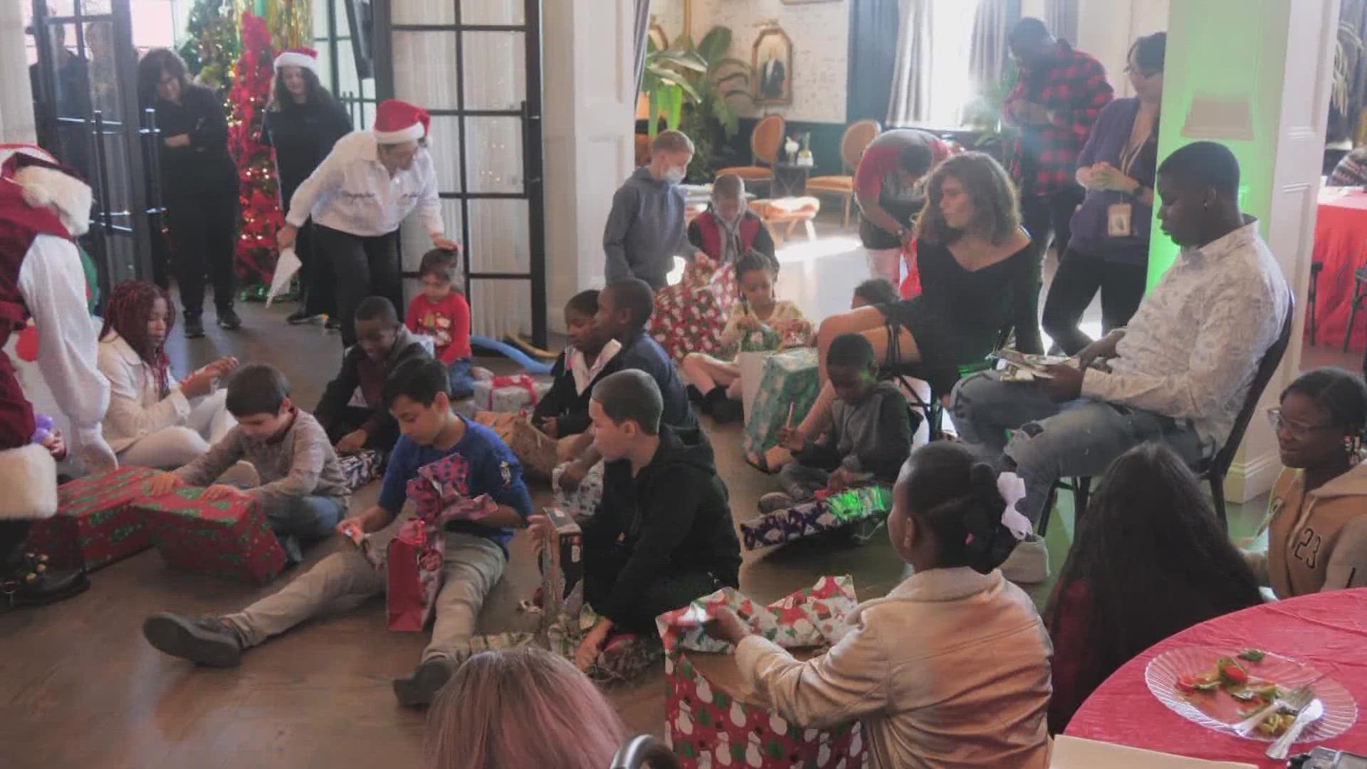 Each year, Dallas World Aquarium workers purchase gifts for children in foster care and Santa hands them all out