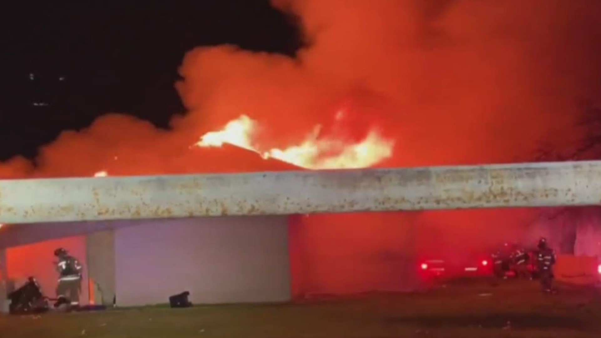A video from a viewer shows part of the building that is on fire collapse on top of the firefighter.