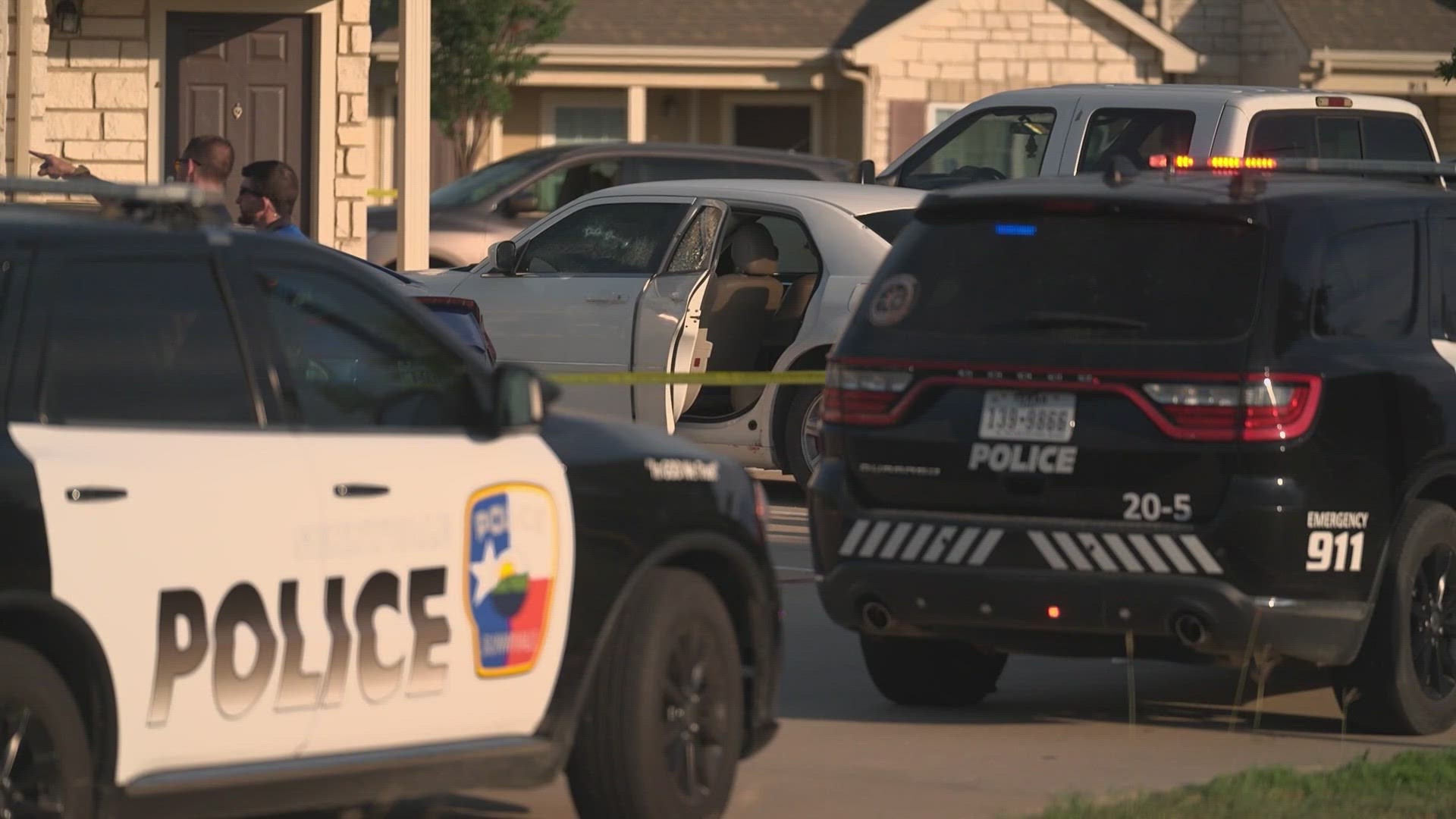 2 people are on the run after a shooting that left a woman dead and 3 children shot while sitting in a car.