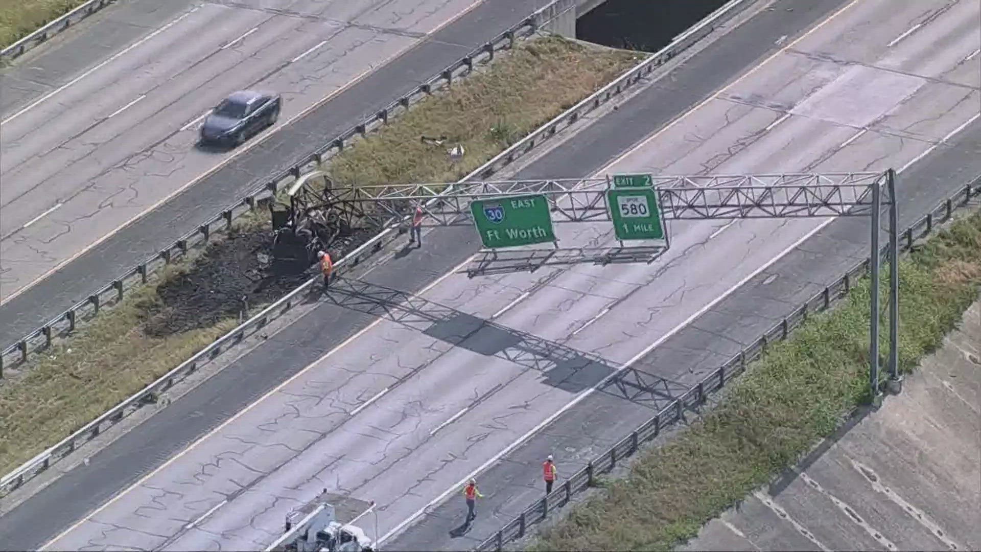 The sign is down in the eastbound lanes of the highway near the Tarrant-Parker County line.