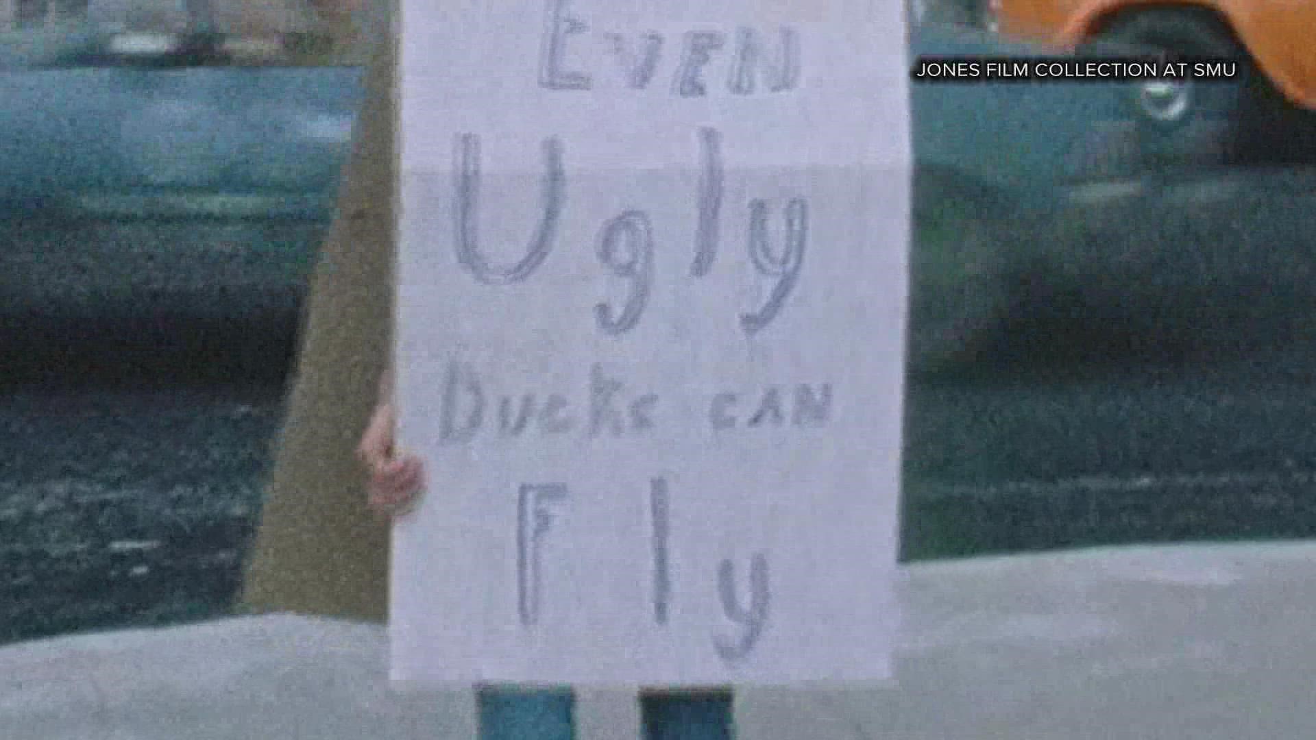 A handful of people calling themselves “Uglies Unlimited” wore signs in front of the AA ticket office in Downtown Fort Worth to protest their hiring practices.