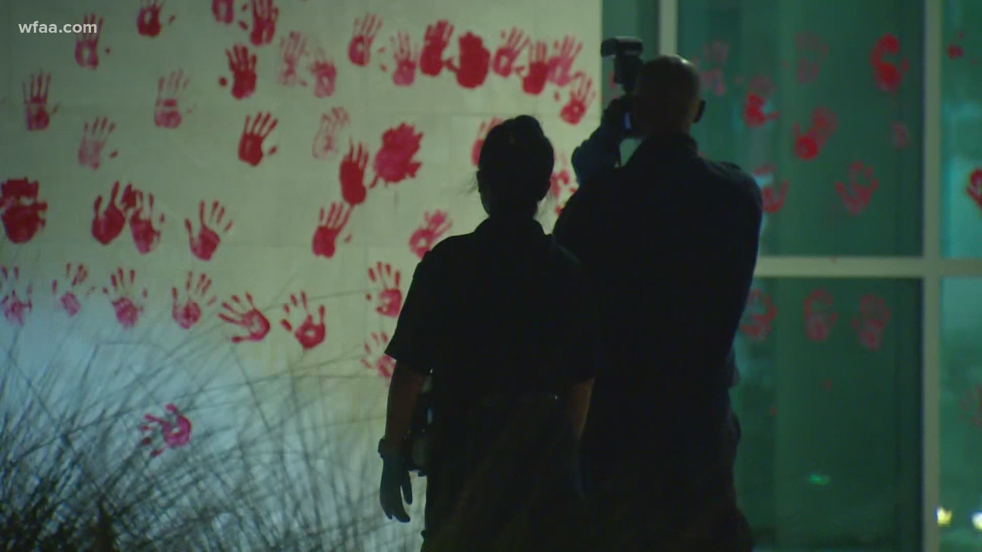 After a protest outside the headquarters of the Dallas Police Department, red handprints were found on the building. Two people were detained and then released.
