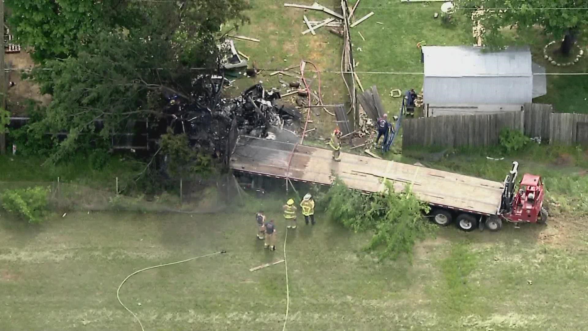 The semi-truck crashed through a backyard near I-635 and Elam Road, killing the driver.