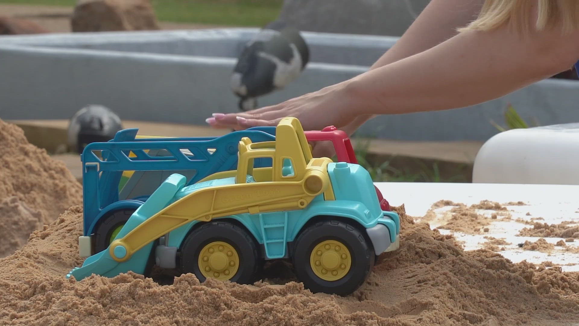 Children brought toy dump trucks to Children's Aquarium Dallas at Fair Park to have them filled with dirt by a real excavator.