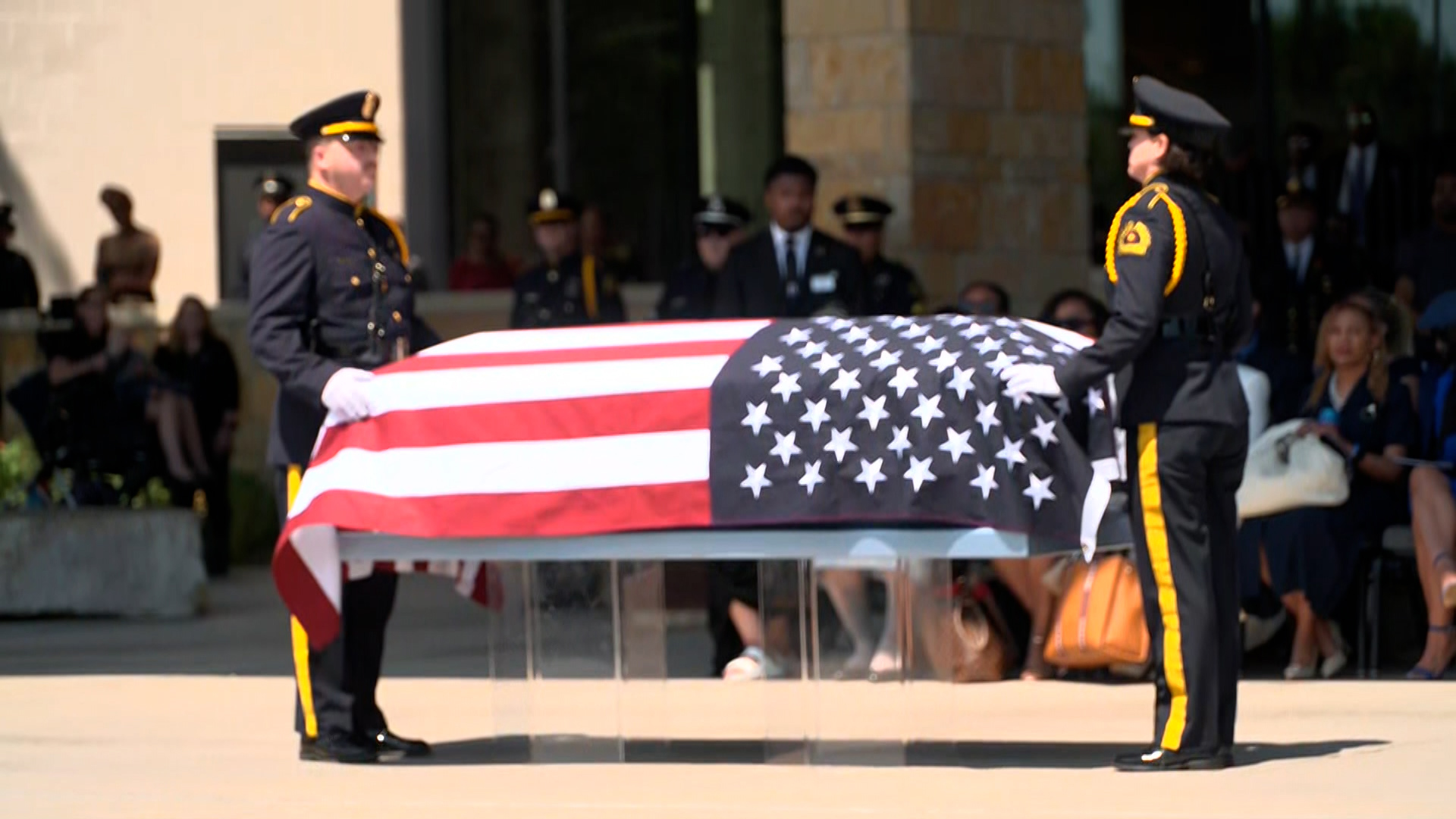 Dallas police honor late officer Darron Burks with a 21-gun salute after his celebration of life service at Watermark Church.