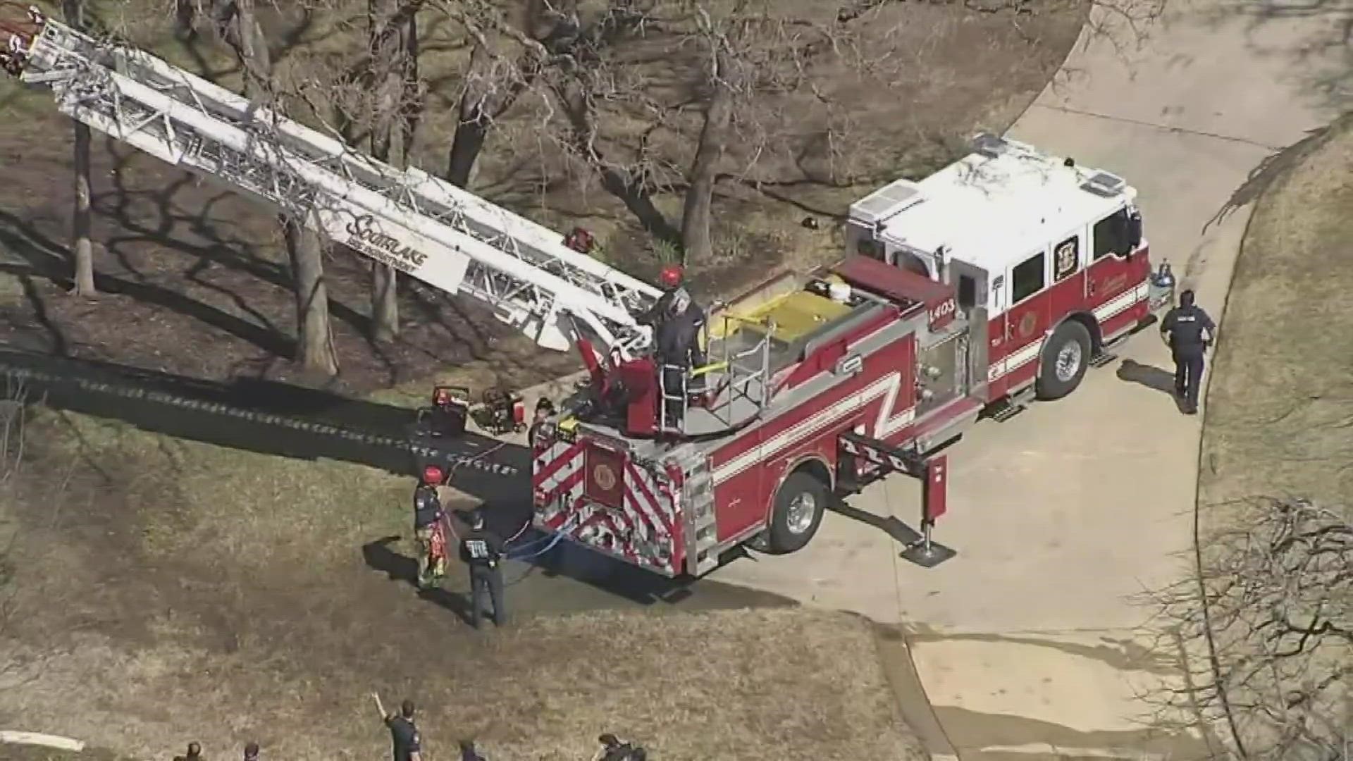 When first responders arrived, they found a man unconscious and suspended by a harness in a tree, police said.