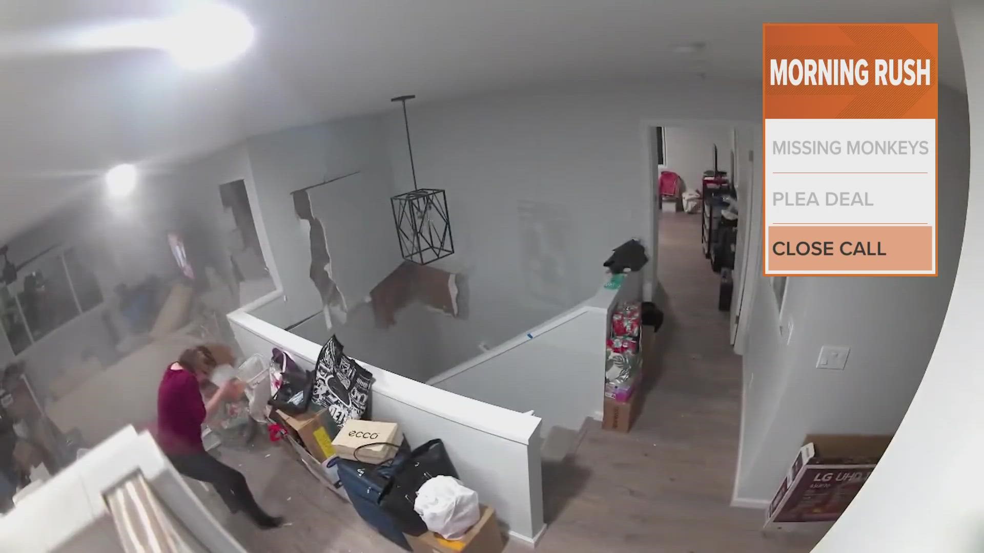 A camera inside the house captured the shocking moment a boulder came crashing through the family's living room.
