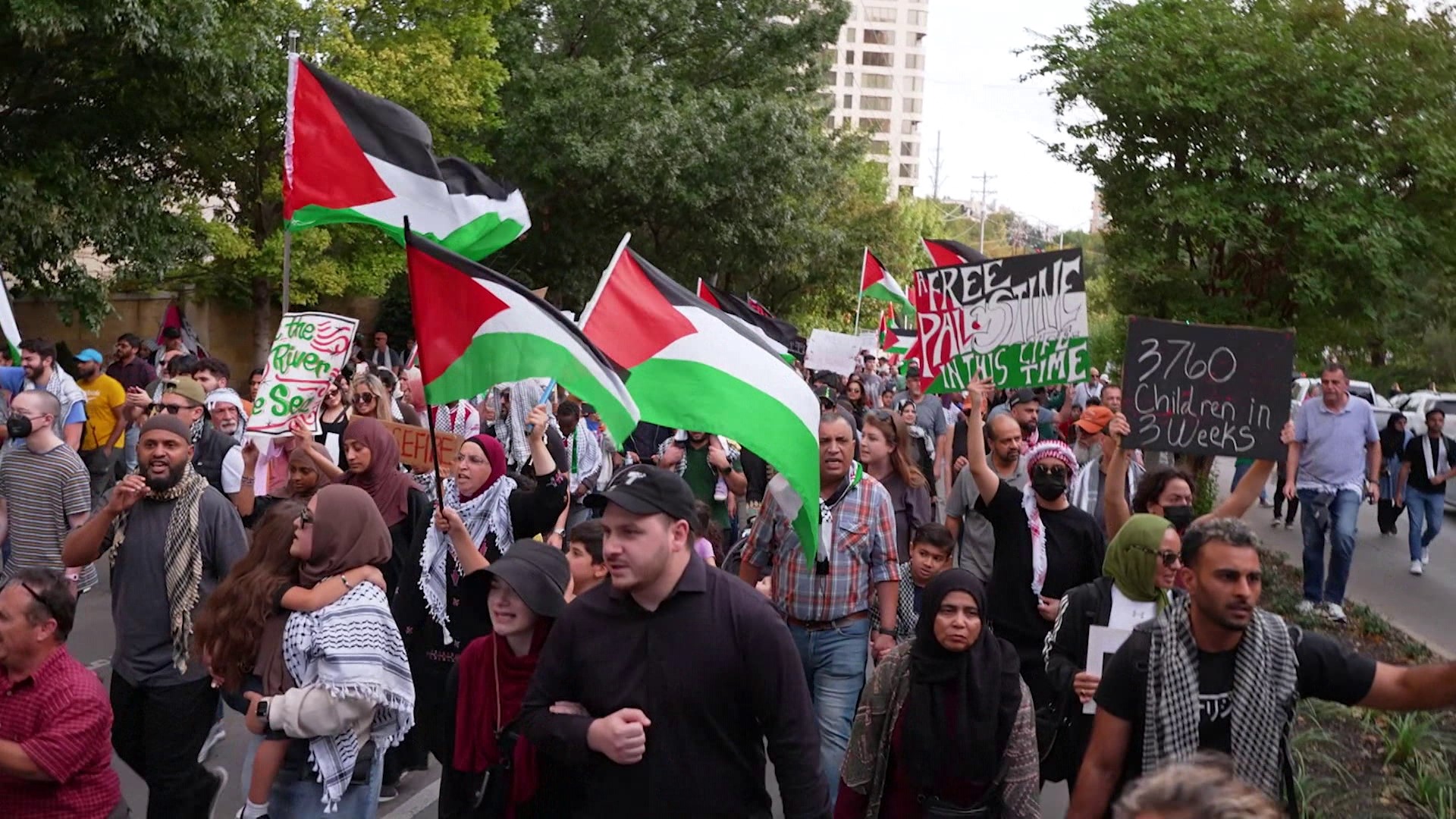 More than 1,000 people carrying Palestinian flags marched Sunday around Turtle Creek Park.