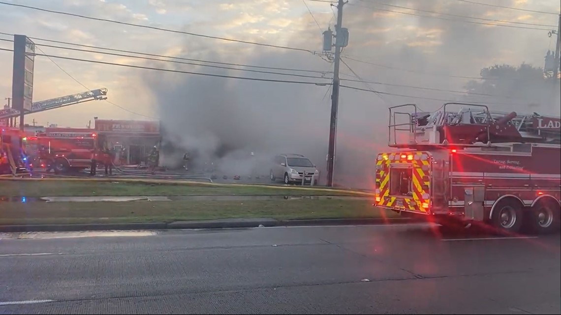 About 100 firefighters fight the blaze at the Army Navy Thrift Store on Harry Hines Boulevard