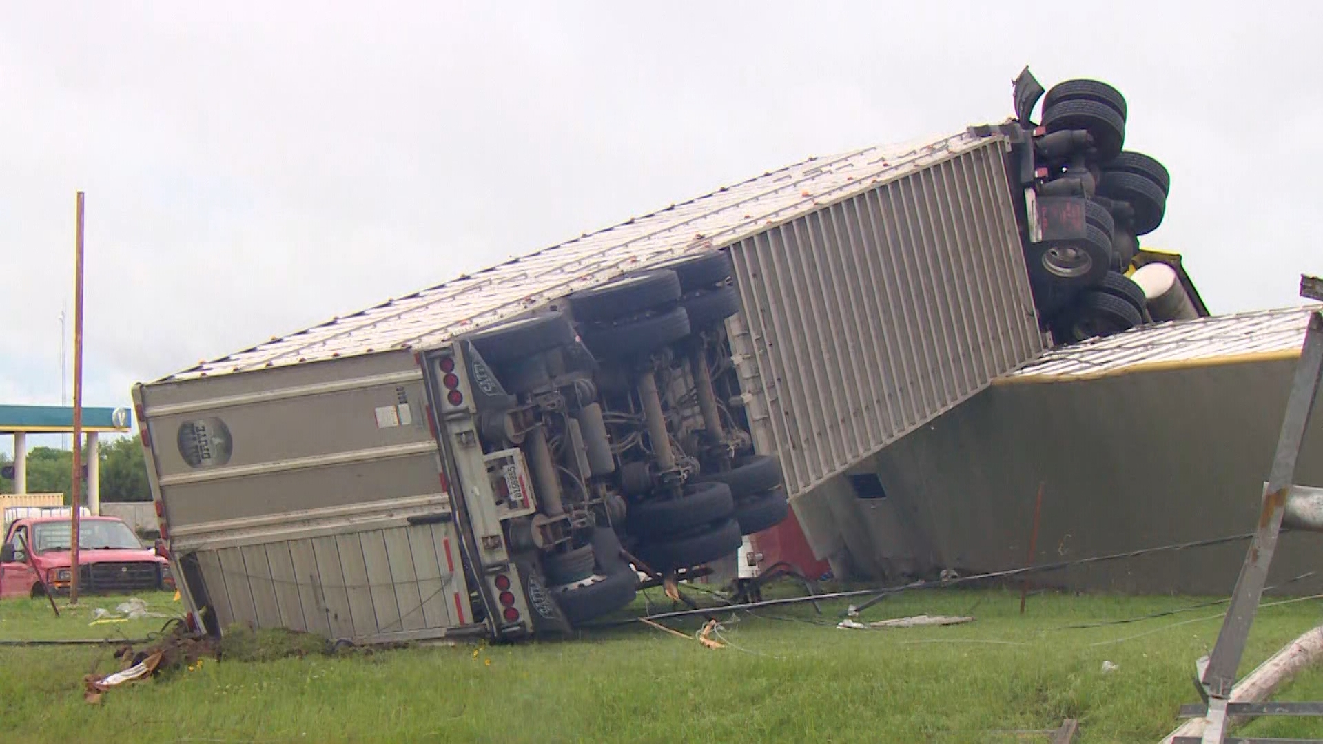 The morning after a tornado swept through Marietta, Okla. revealed damage to buildings and overturned cars.