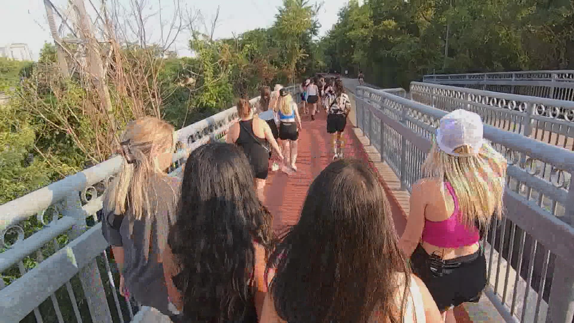A group of more than 100 young women, dressed in their best athletic outfits and sets walking, talking and laughing on the Katy Trail in Dallas.