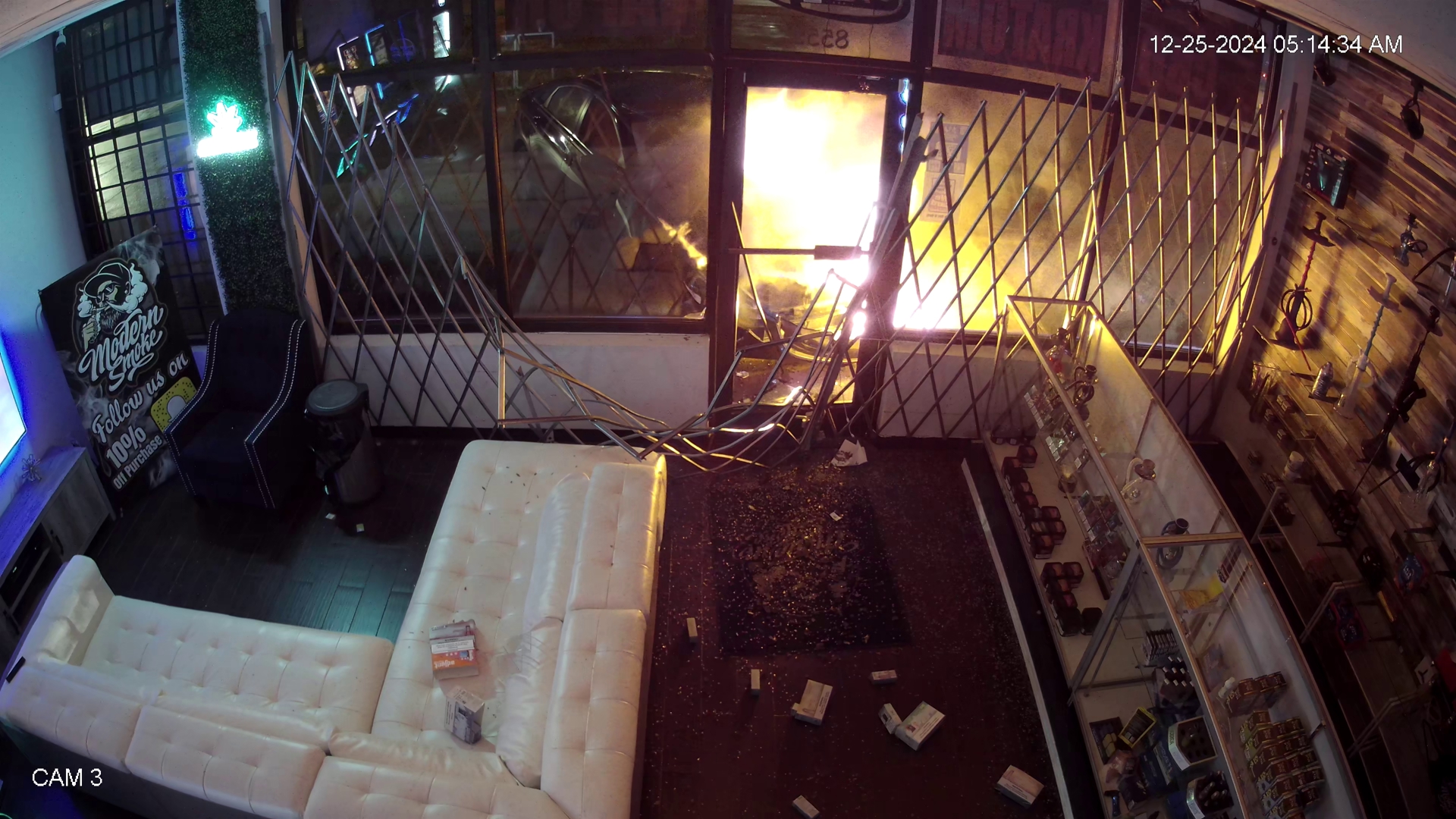 Surveillance footage shows the car crash into the front of the shop, and later, the car in flames.