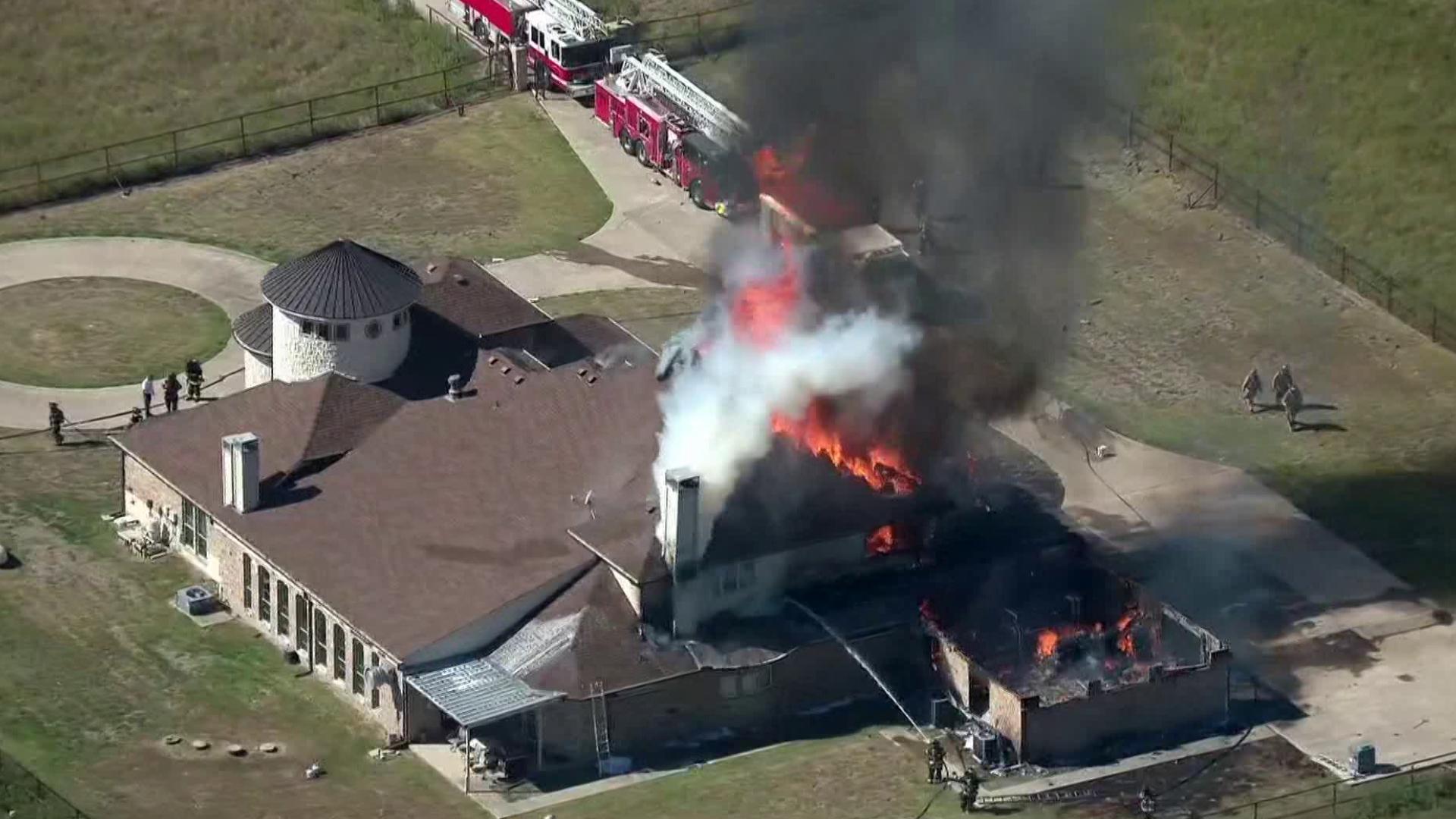 Heavy fire burning at a mansion in North Texas