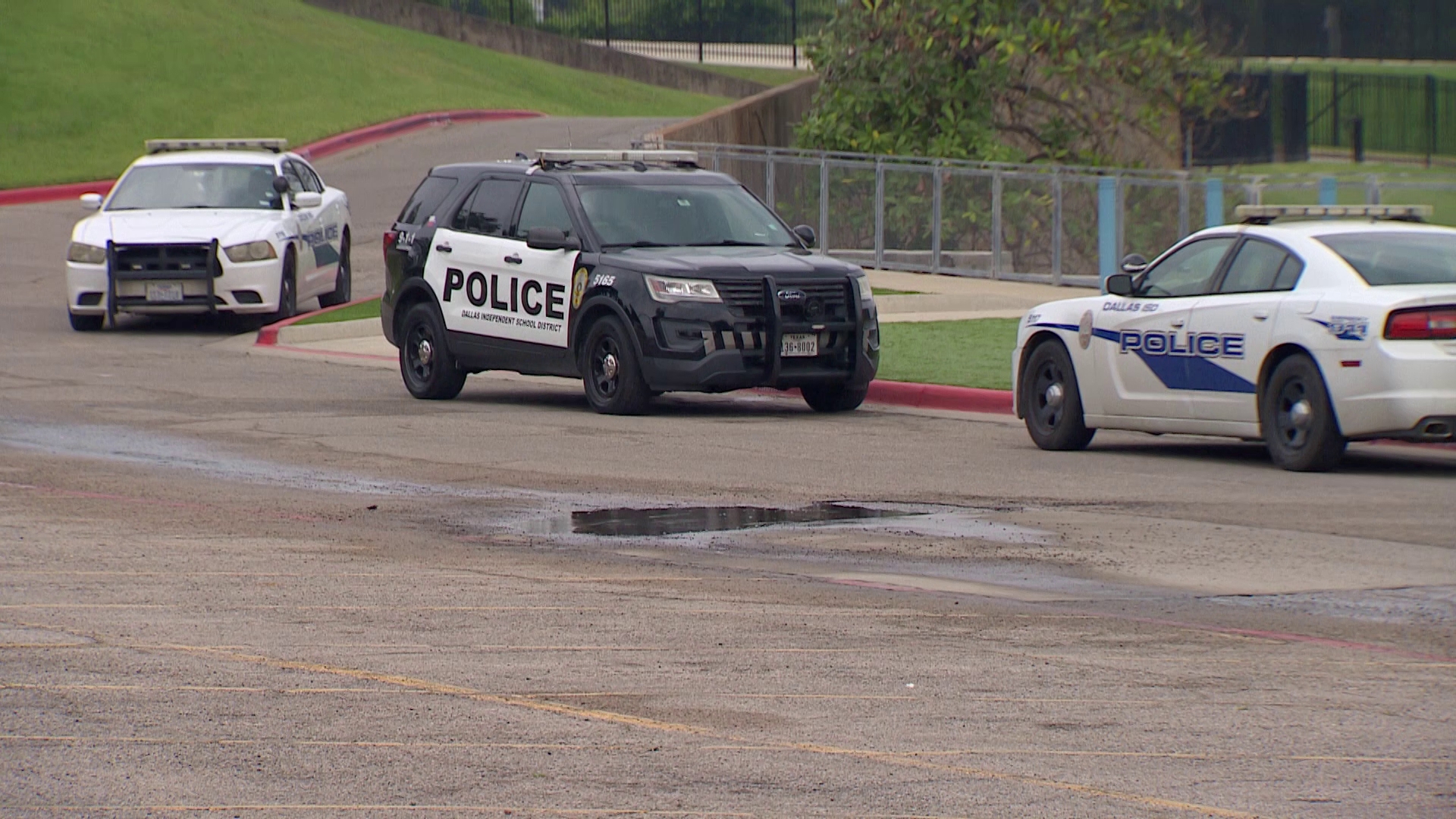 Dallas Police said a school staffer was giving two football players rides home after practice Thursday when someone pulled alongside them and started shooting.