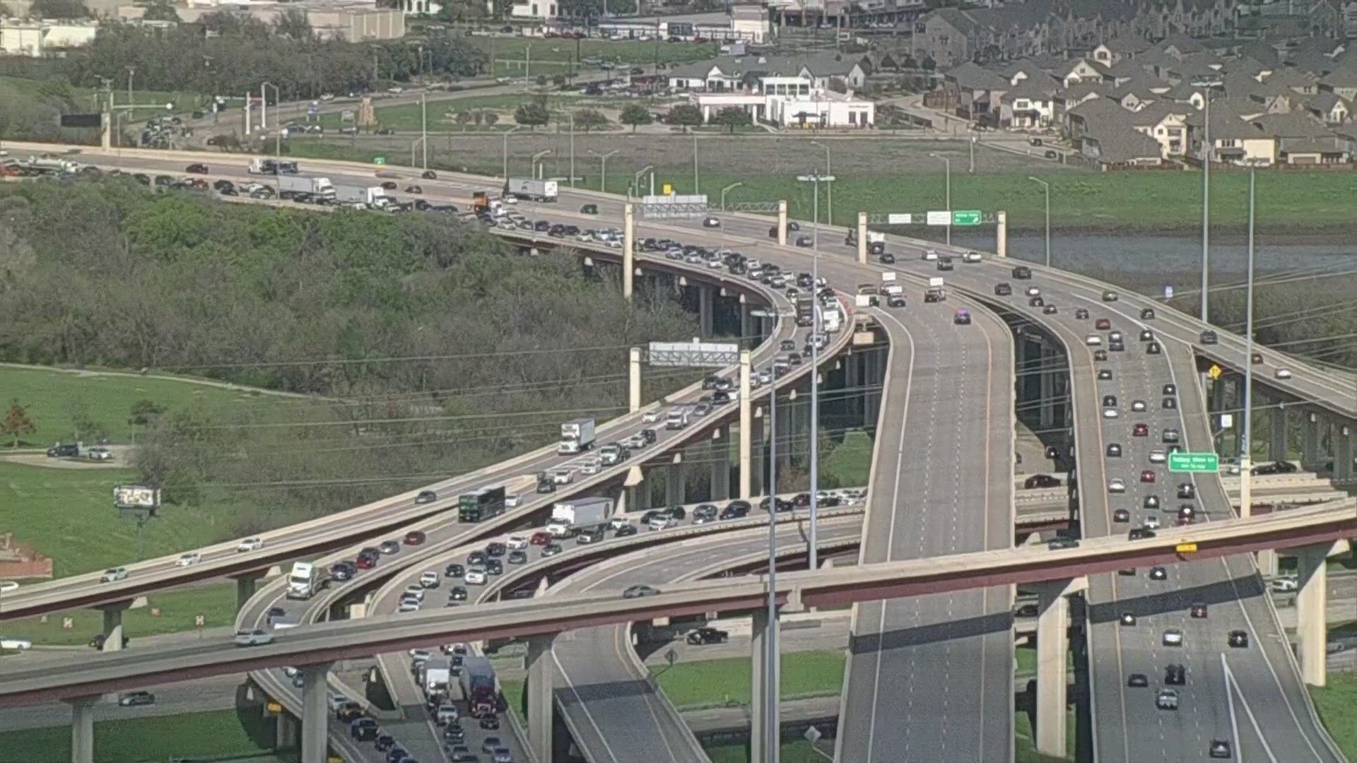 Irving police said a man burst through a traffic barricade at a high rate of speed, got out of his car on the highway and approached officers with a knife in-hand.