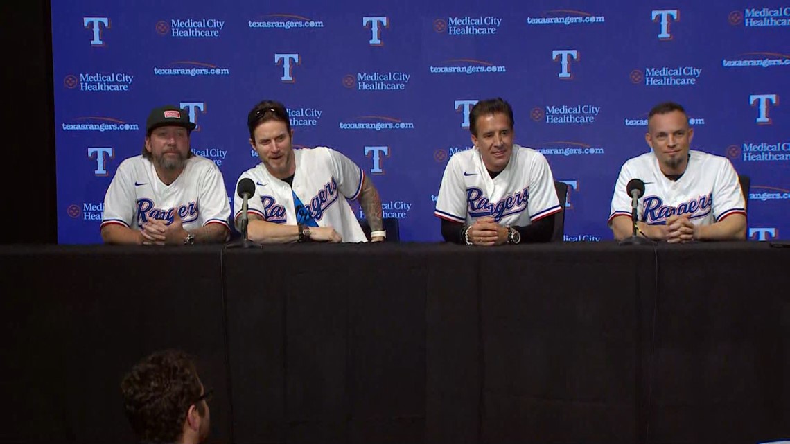 Creed band members at ALCS Game 3 in Texas Rangers gear