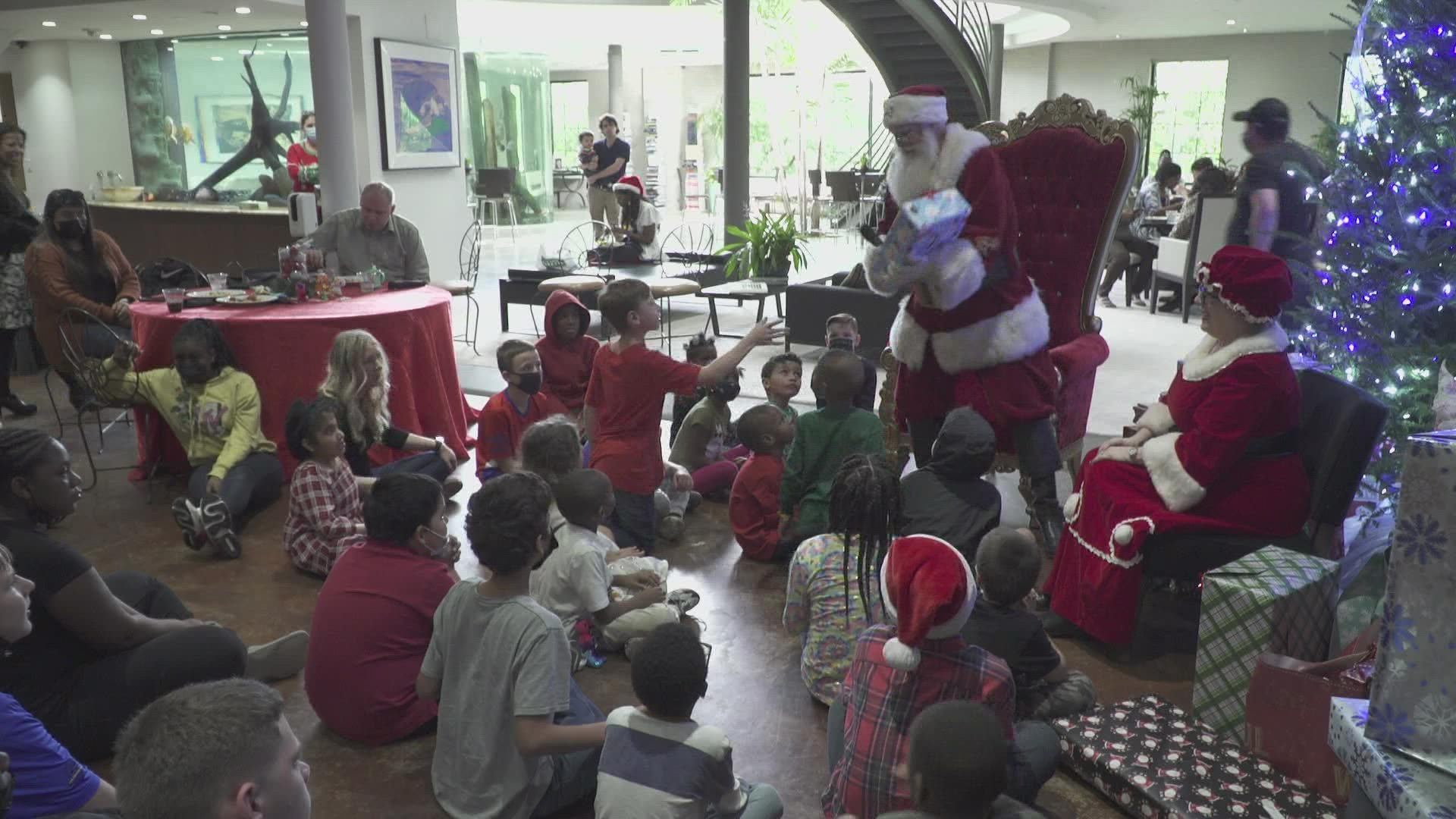 Dallas World Aquarium purchases gifts for all of the children in foster care and Santa handed them all out!